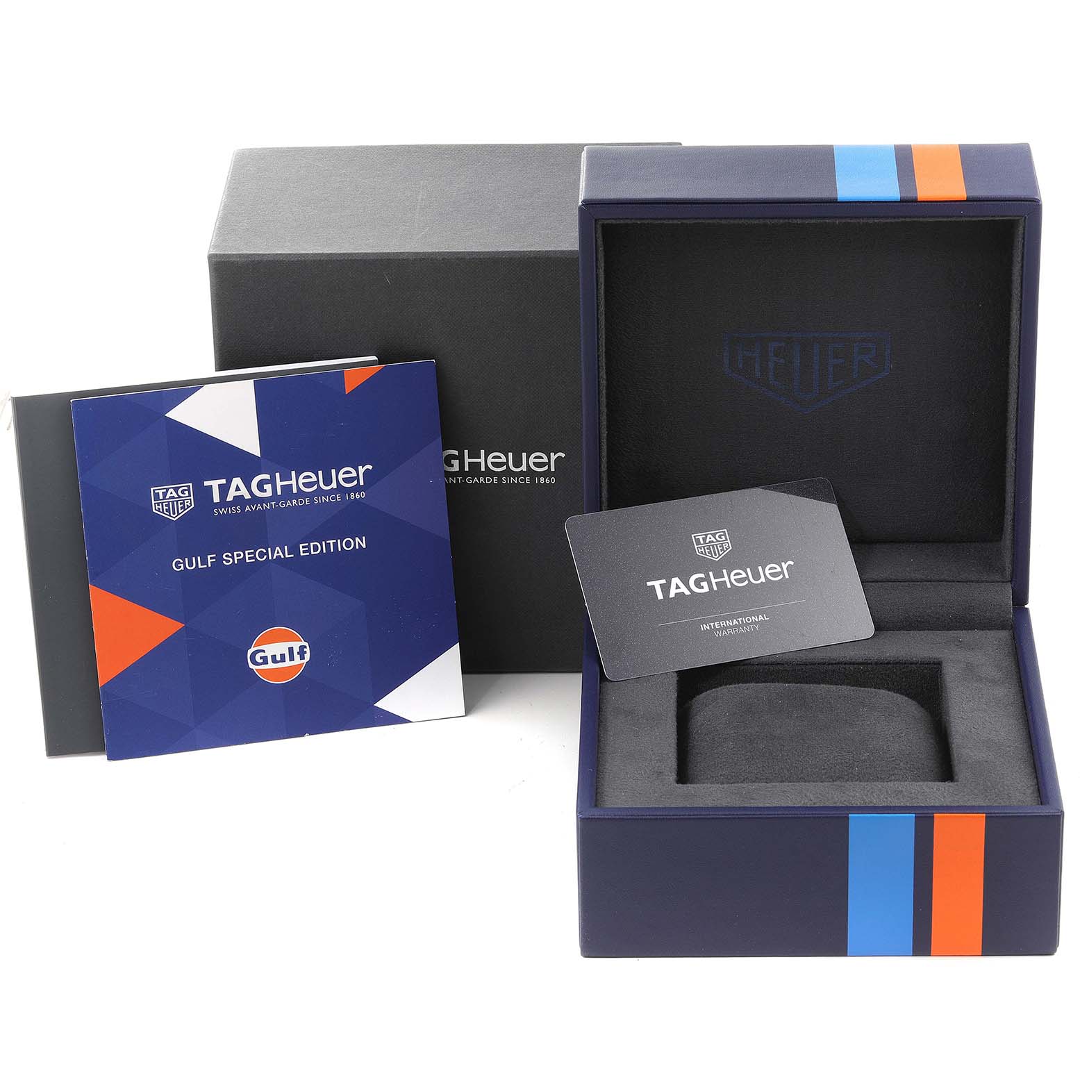 This image shows the packaging and accessories for the Tag Heuer Monaco CAW211R.FC6401 Men's Stainless Steel Blue Dial CAW211R.FC6401 Men's Stainless Steel Blue Dial model, including a box, manual, and warranty card.