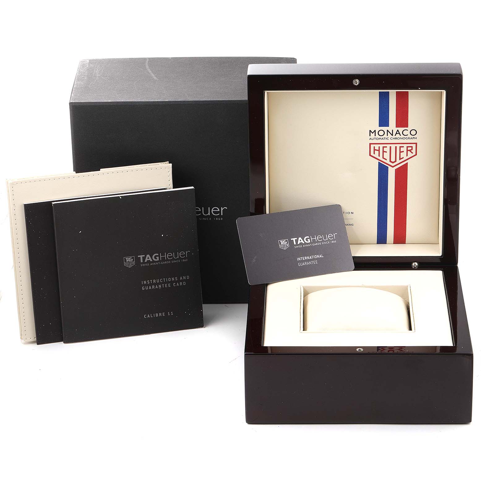The image shows the packaging, box, manuals, and guarantee card for the Tag Heuer Monaco Limited Edition watch.