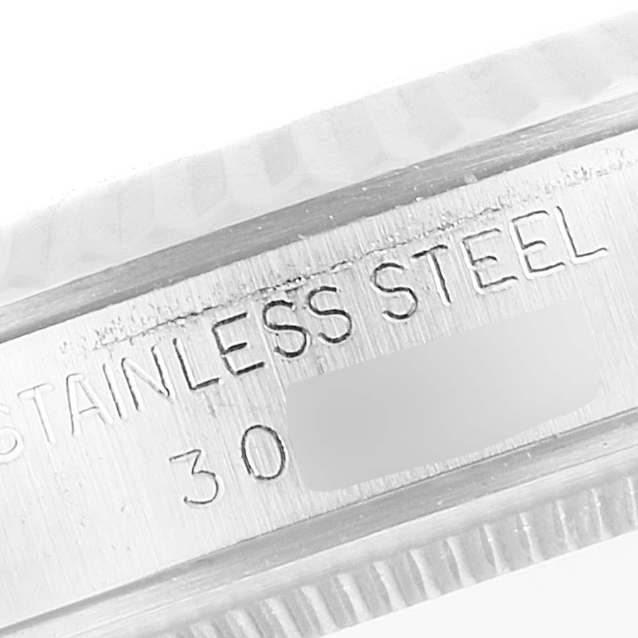 This close-up image shows the side of the stainless steel case of the Tudor Prince 74034 Men's Stainless Steel Silver Dial 74034 Men's Stainless Steel Silver Dial watch, including part of its engraving.