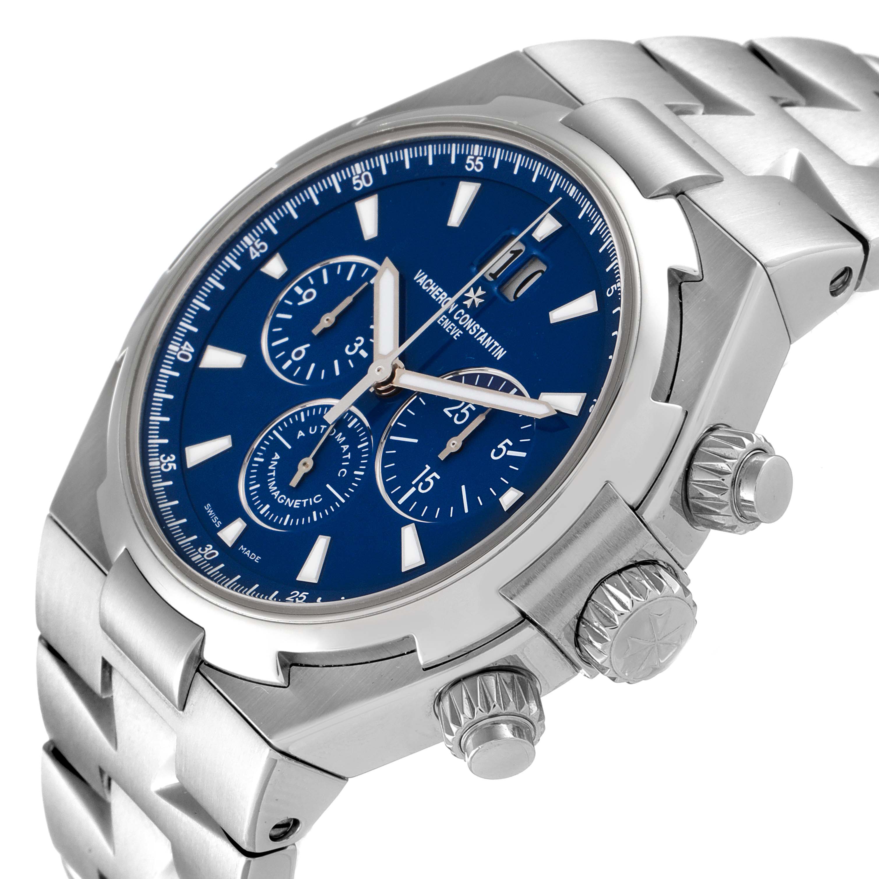 The image shows a Vacheron Constantin Overseas 49150/000A-9745 Men's Stainless Steel Blue Dial 49150/000A-9745 Men's Stainless Steel Blue Dial model watch at an oblique angle highlighting the dial, crown, and pushers.