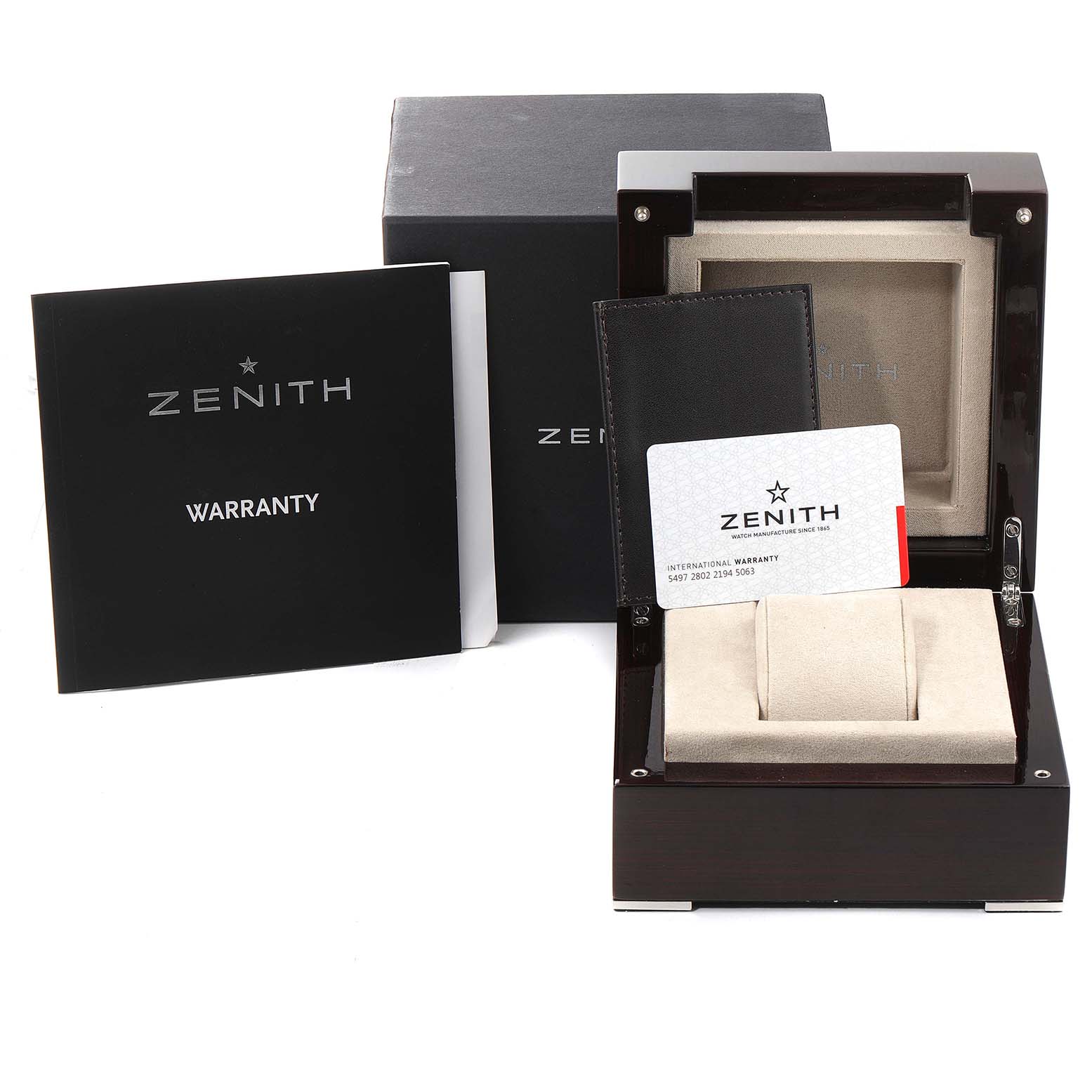 This image shows the packaging, warranty card, and watch box for the El Primero model by Zenith from a front angle.