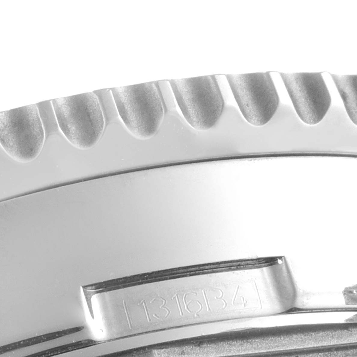 This close-up image shows the ridged bezel and part of the case with an engraved serial number on a Breitling Navitimer A2135024/BE62-453A Men's Stainless Steel Black Dial A2135024/BE62-453A Men's Stainless Steel Black Dial watch.