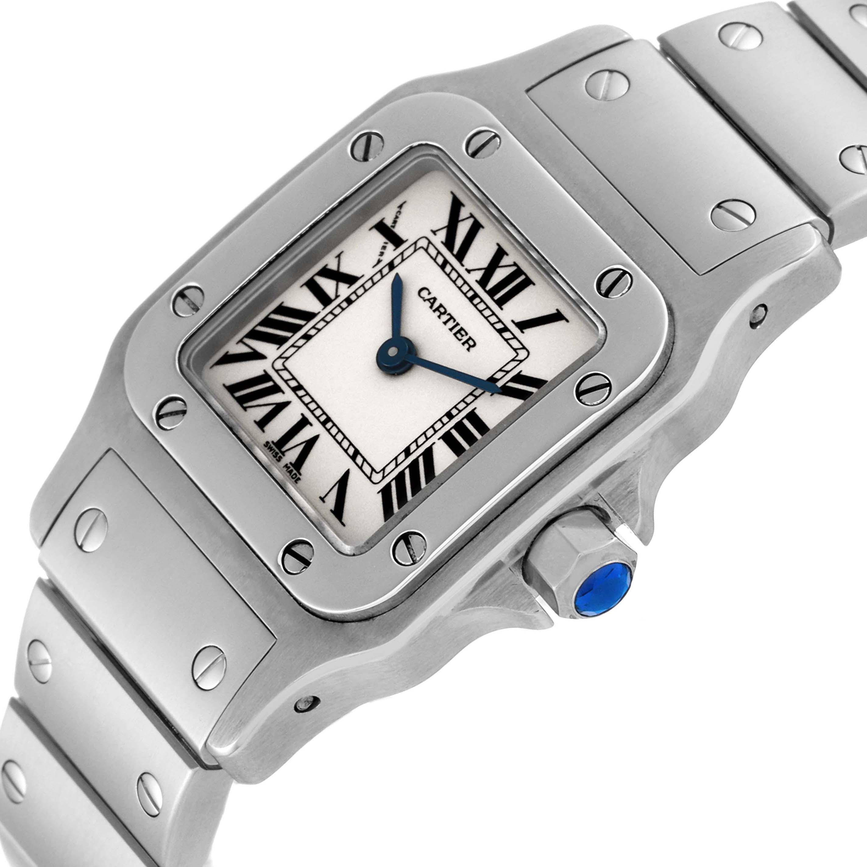 The image shows a Santos model Cartier watch, focusing on the face, bezel, and part of the bracelet at a slight angle.