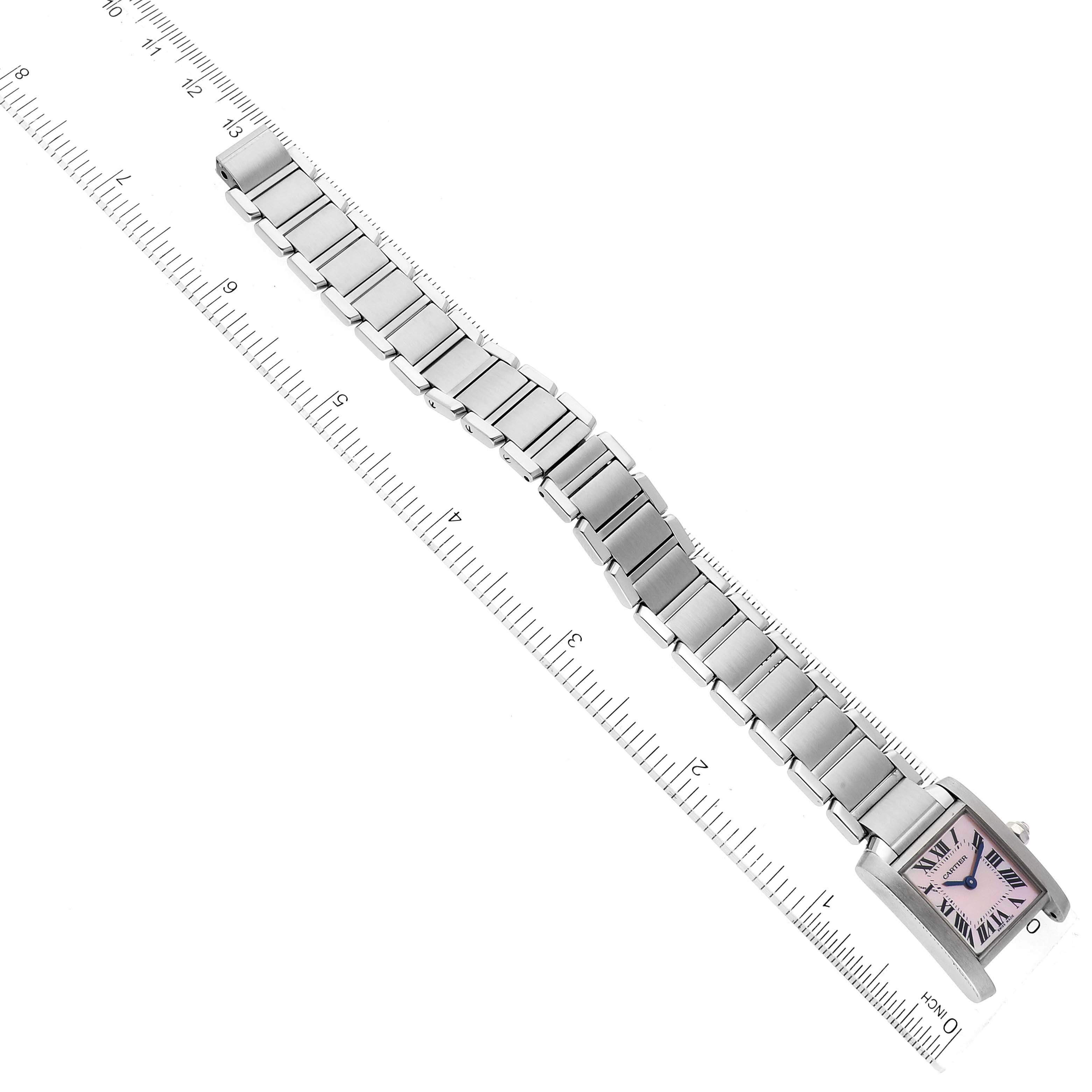 The image shows a Cartier Tank Francaise W51028Q3 Women
s Stainless Steel Mother of Pearl Dial W51028Q3 Women
s Stainless Steel Mother of Pearl Dial watch laid flat with a metal link bracelet, next to a ruler.