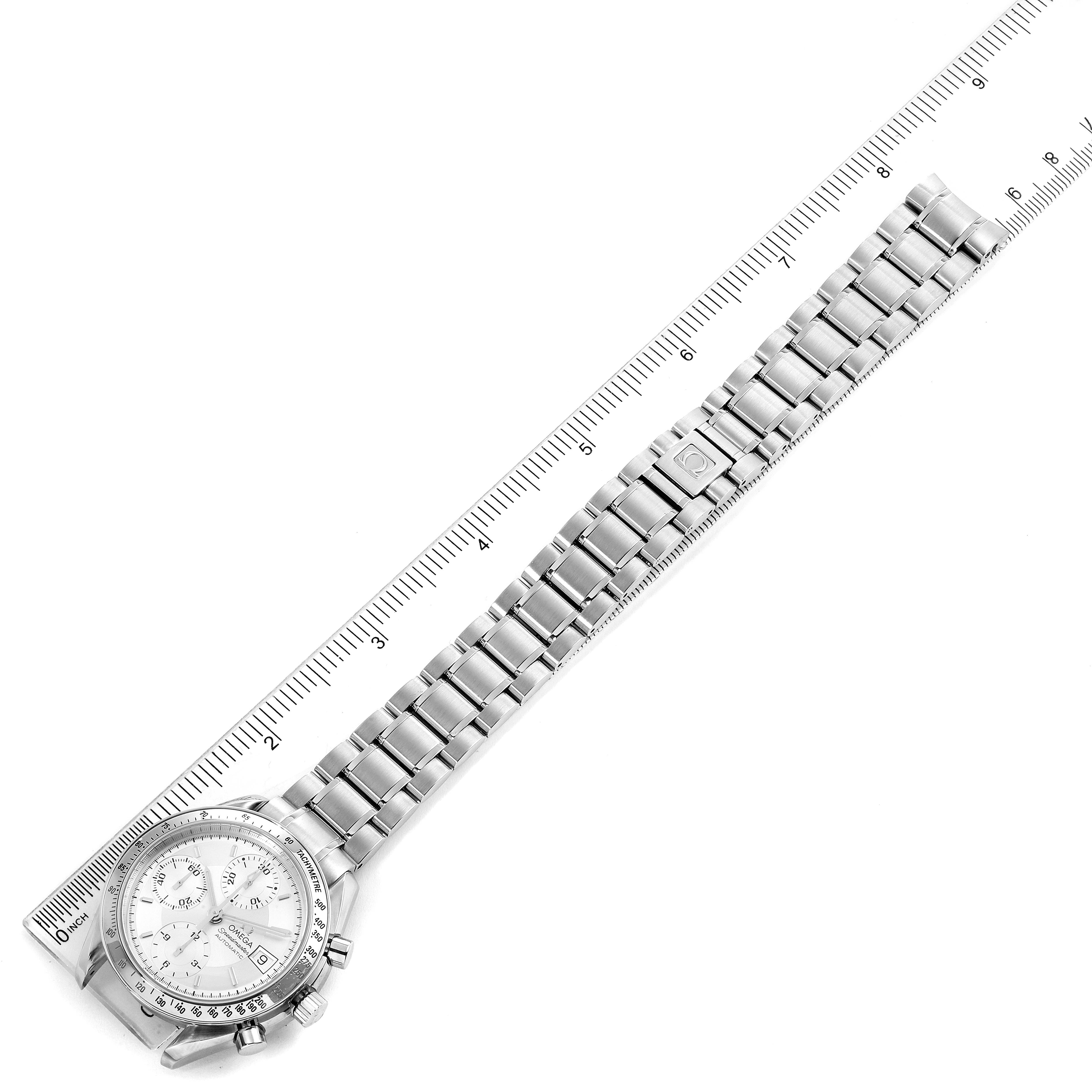 The Omega Speedmaster 3513.30.00 Men
s Stainless Steel Silver Dial 3513.30.00 Men
s Stainless Steel Silver Dial watch is shown at an overhead angle, displaying the full length of its metal bracelet alongside a ruler.