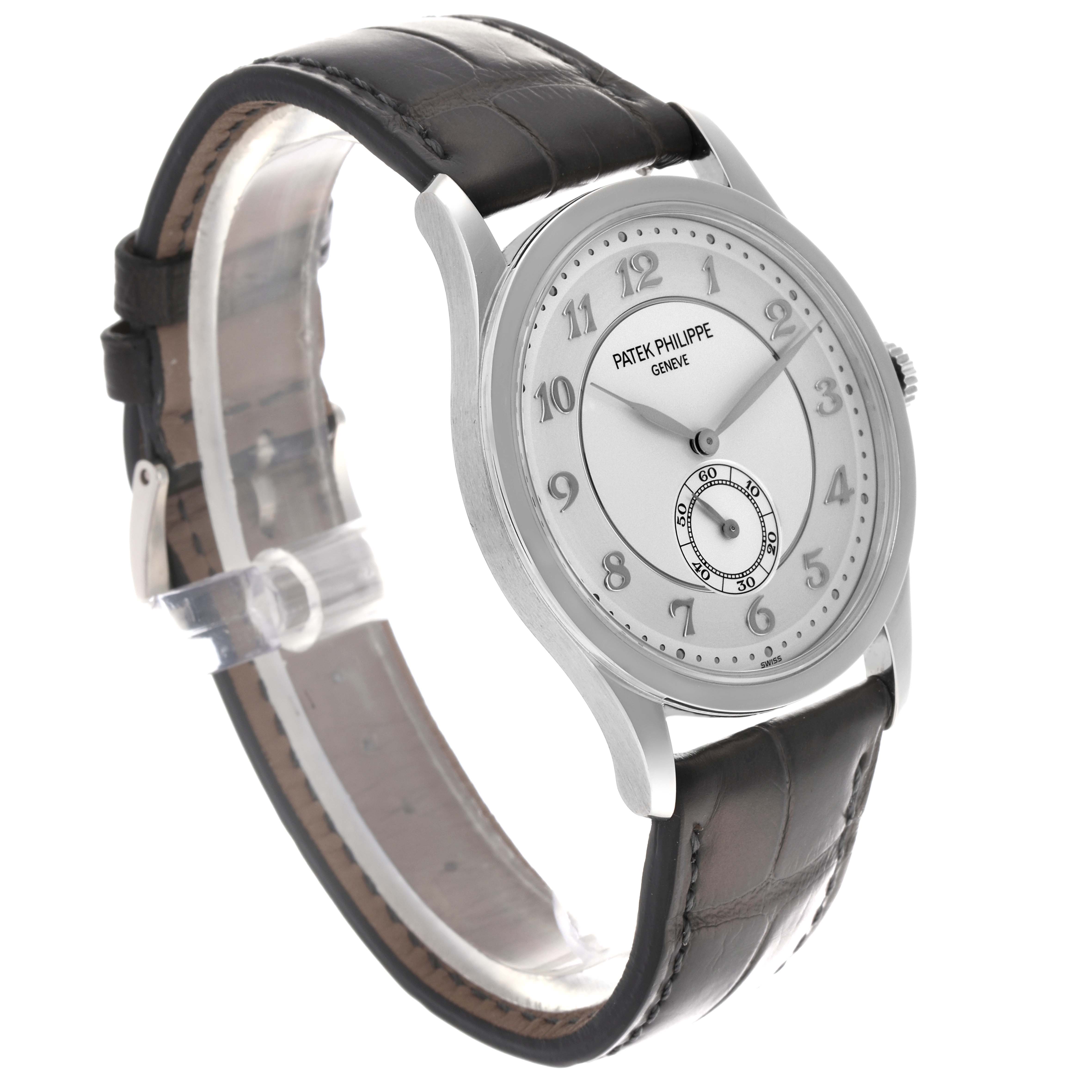 The Patek Philippe Calatrava 5196P-001 Men's Platinum Silver Dial 5196P-001 Men's Platinum Silver Dial watch is shown at a front-side angle, displaying its face, bezel, and leather strap.