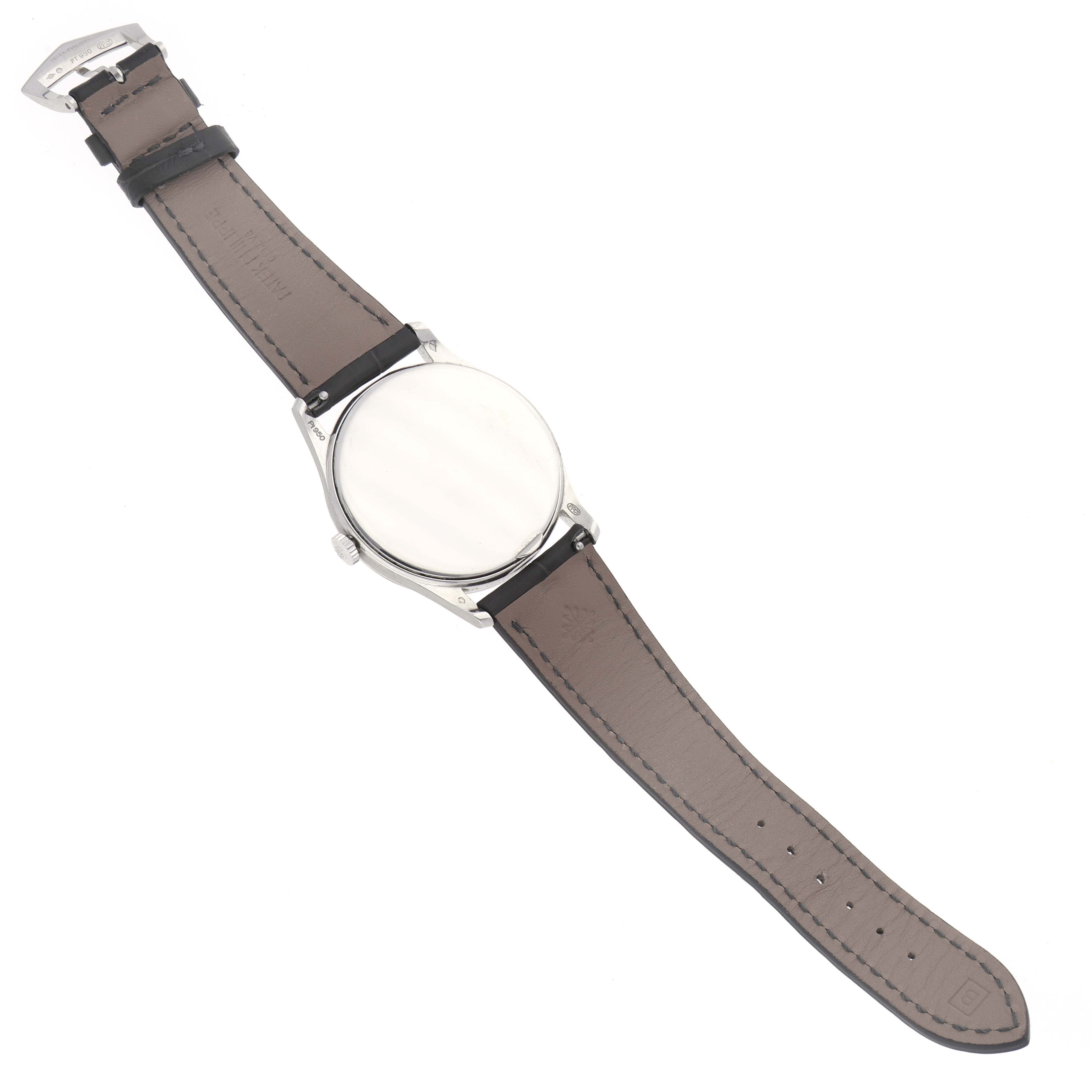 The image shows a Patek Philippe Calatrava 5196P-001 Men's Platinum Silver Dial 5196P-001 Men's Platinum Silver Dial watch laid flat, displaying the strap and case back.