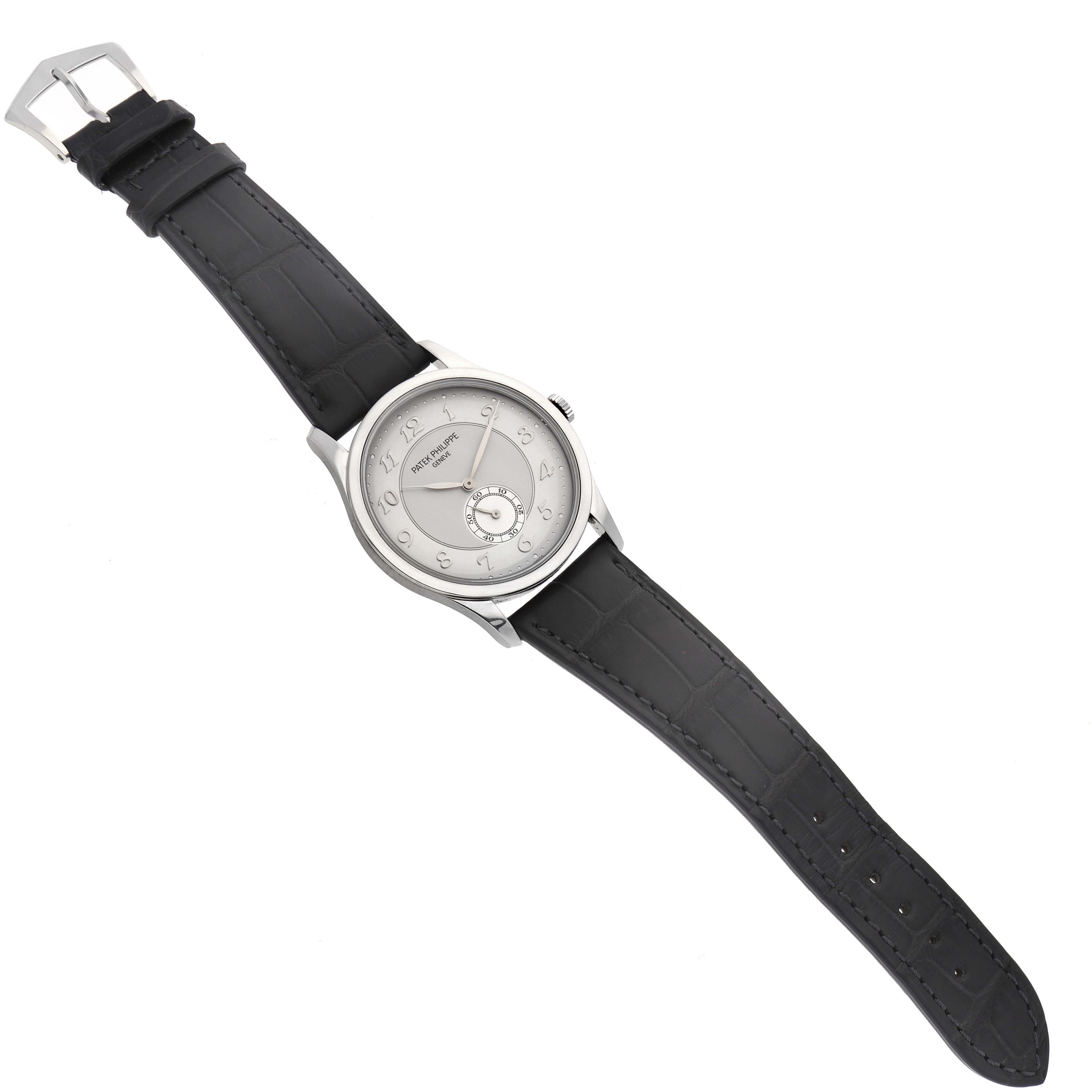 The Patek Philippe Calatrava 5196P-001 Men's Platinum Silver Dial 5196P-001 Men's Platinum Silver Dial watch is shown from a top-down angle, displaying the face, case, and full leather strap.
