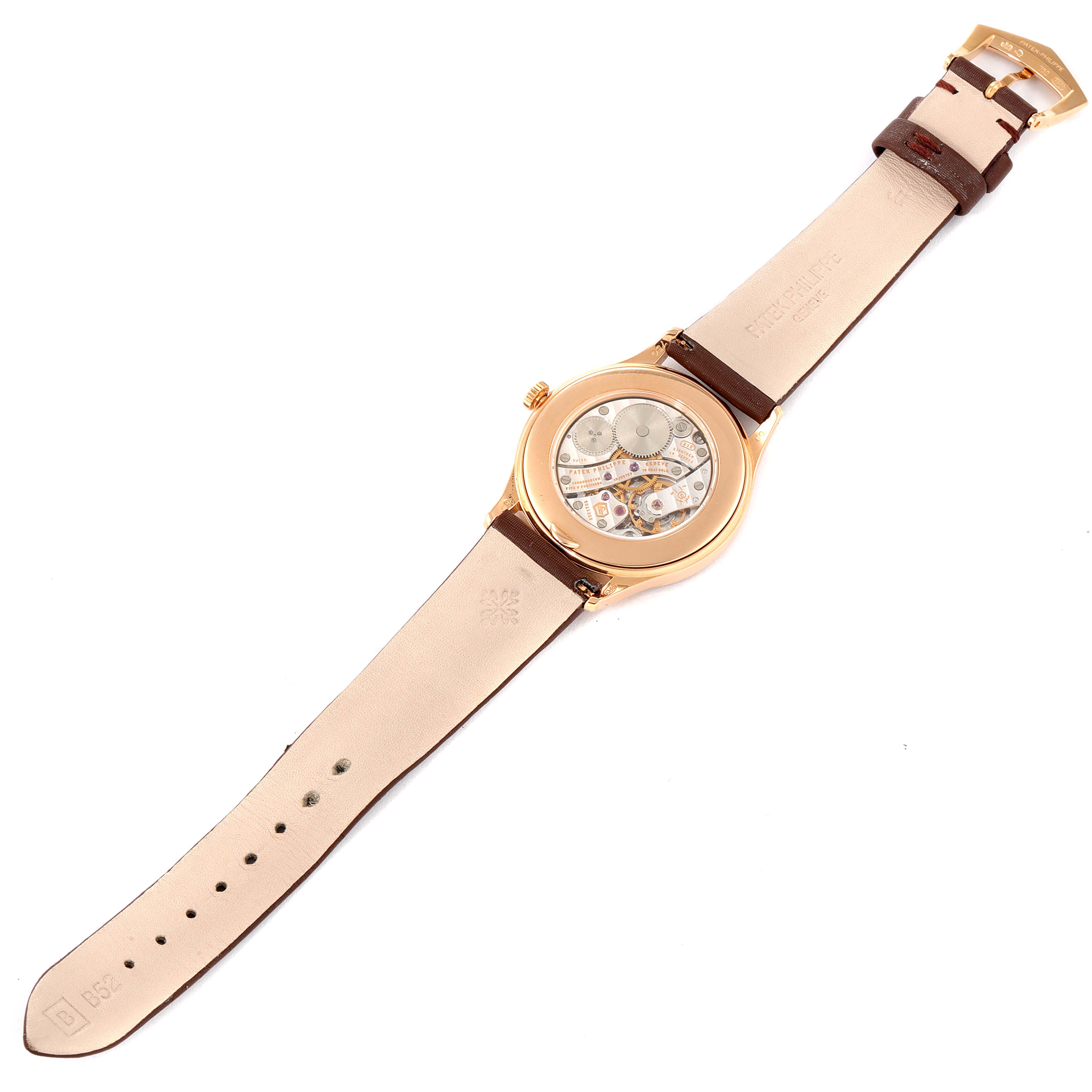 The image shows the back view of a Patek Philippe Calatrava 4897R-001 Women's Rose Gold Brown Dial 4897R-001 Women's Rose Gold Brown Dial watch, displaying its inner mechanism and the leather strap.