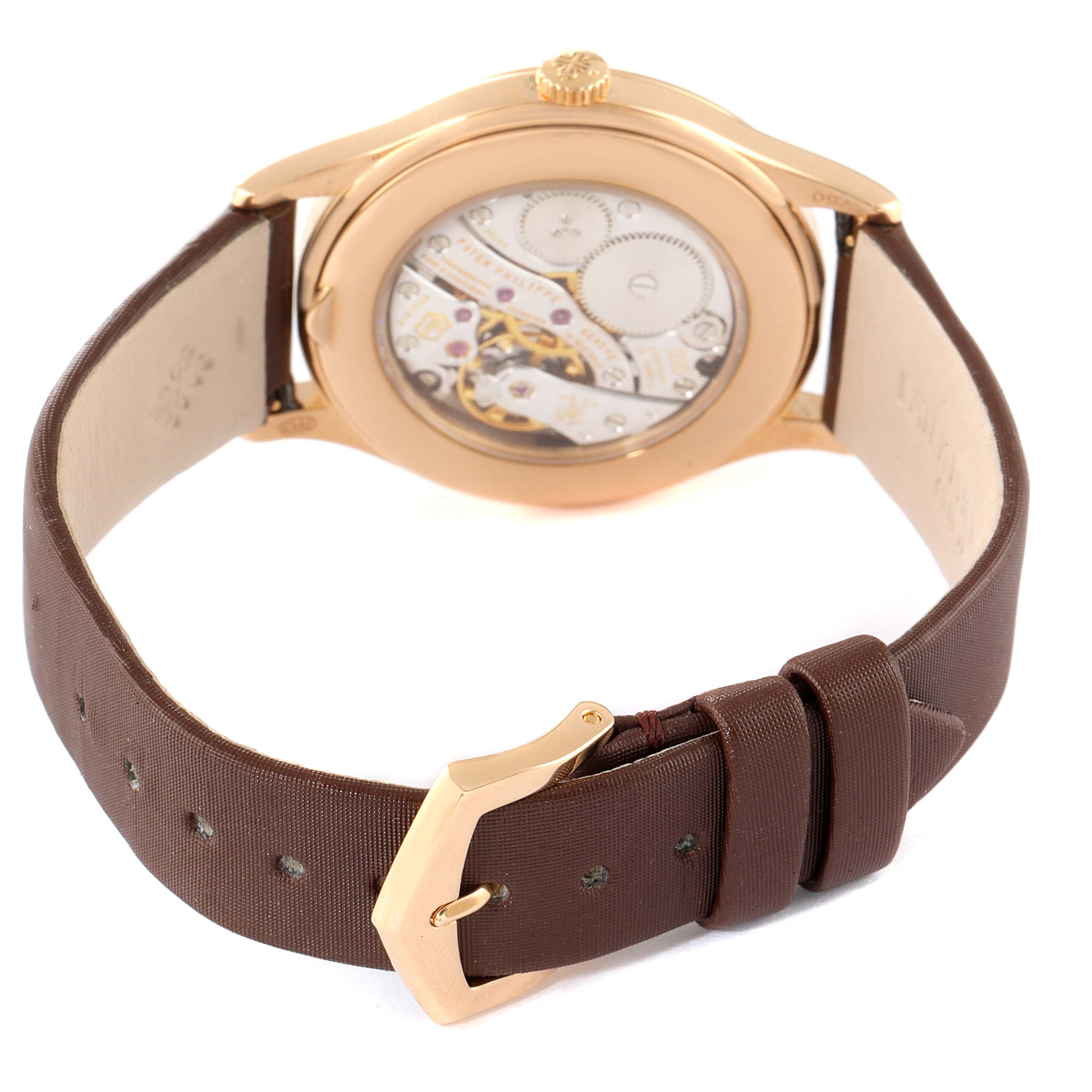 The image shows the back view of a Patek Philippe Calatrava 4897R-001 Women's Rose Gold Brown Dial 4897R-001 Women's Rose Gold Brown Dial watch, highlighting its mechanical movement and brown leather strap.