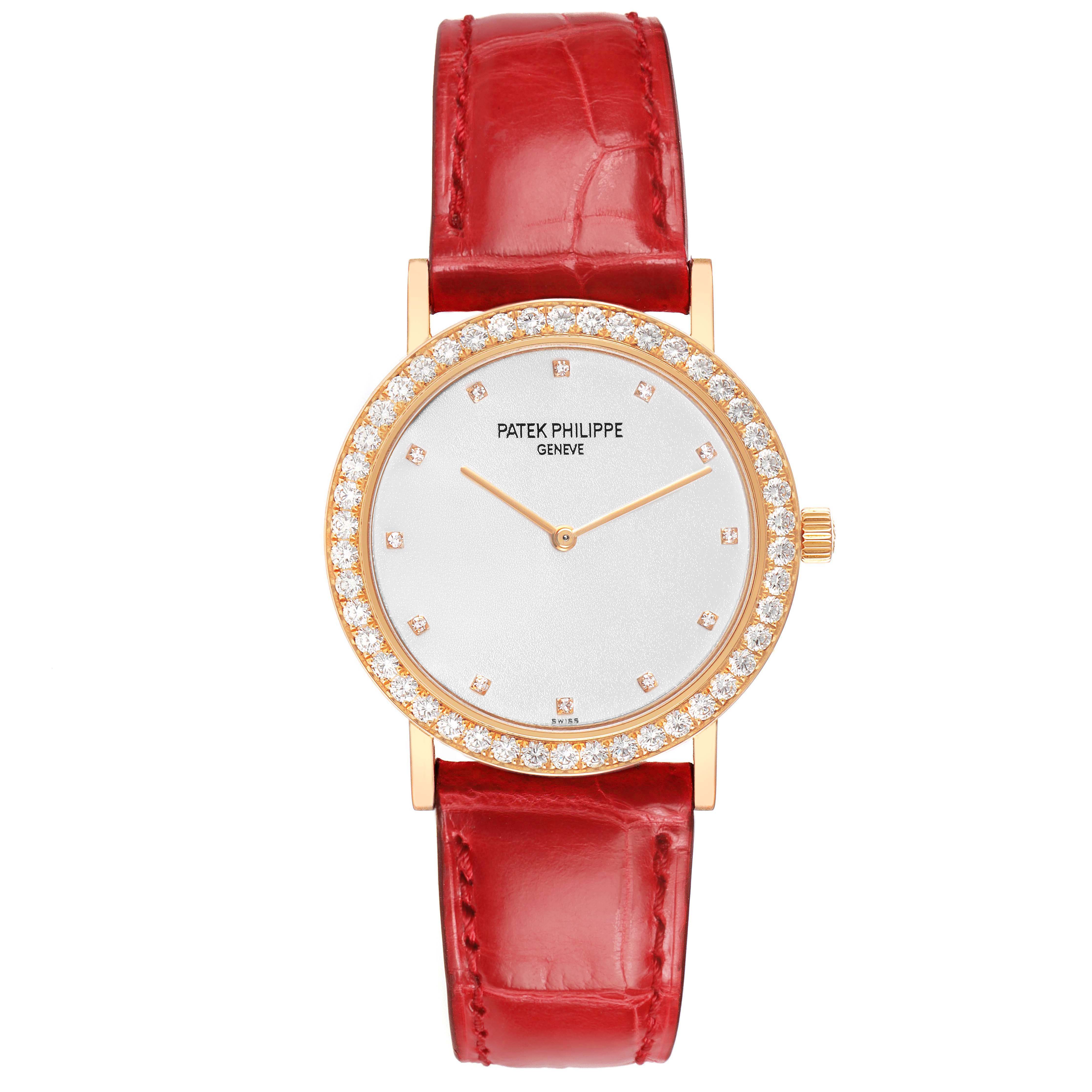 The Patek Philippe Calatrava 5006R Men's Rose Gold Silver Dial watch is shown from a top-down angle, highlighting the diamond bezel and red leather strap.