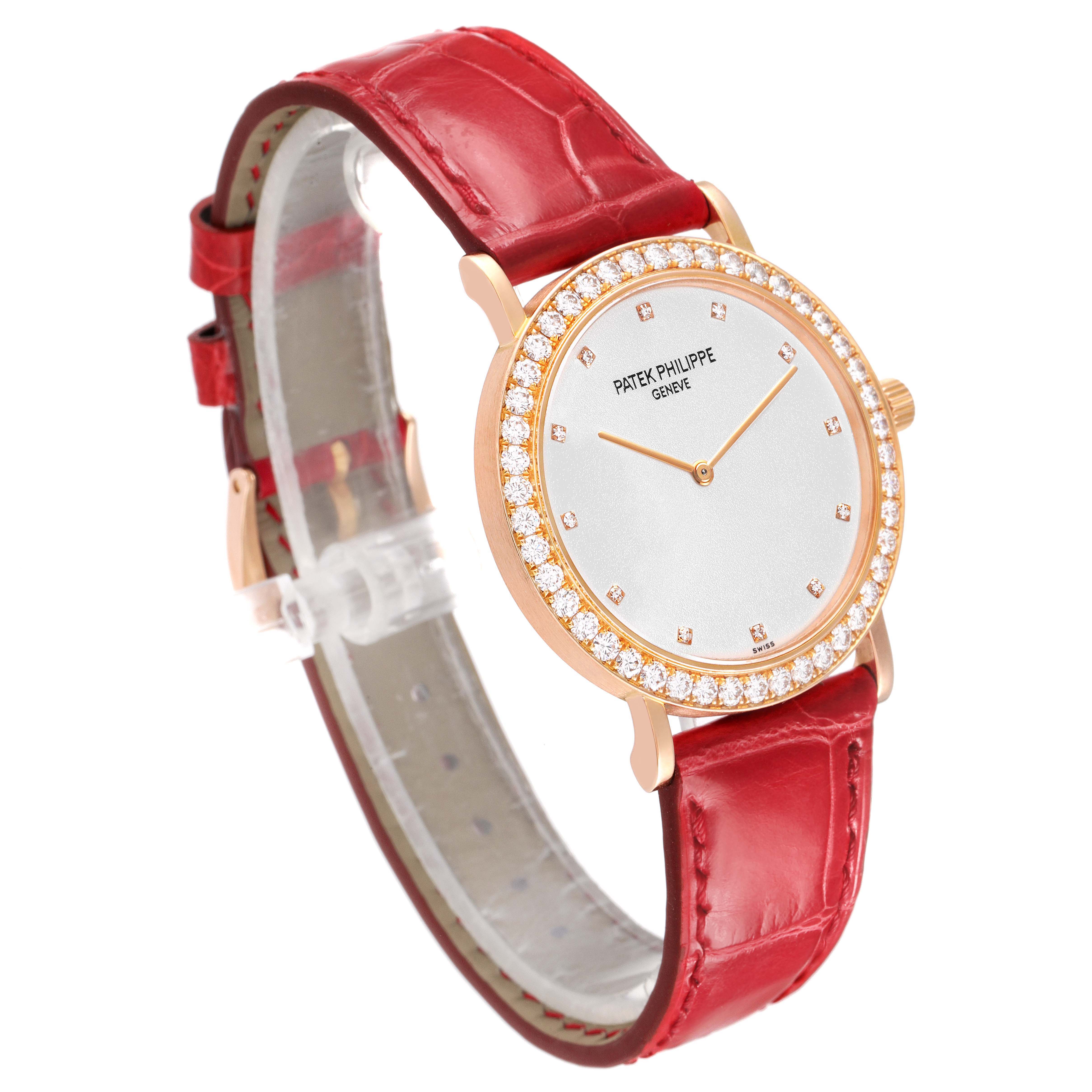 The Patek Philippe Calatrava 5006R Men's Rose Gold Silver Dial watch is shown at a slight angle, highlighting the watch face, diamond bezel, and red leather strap.
