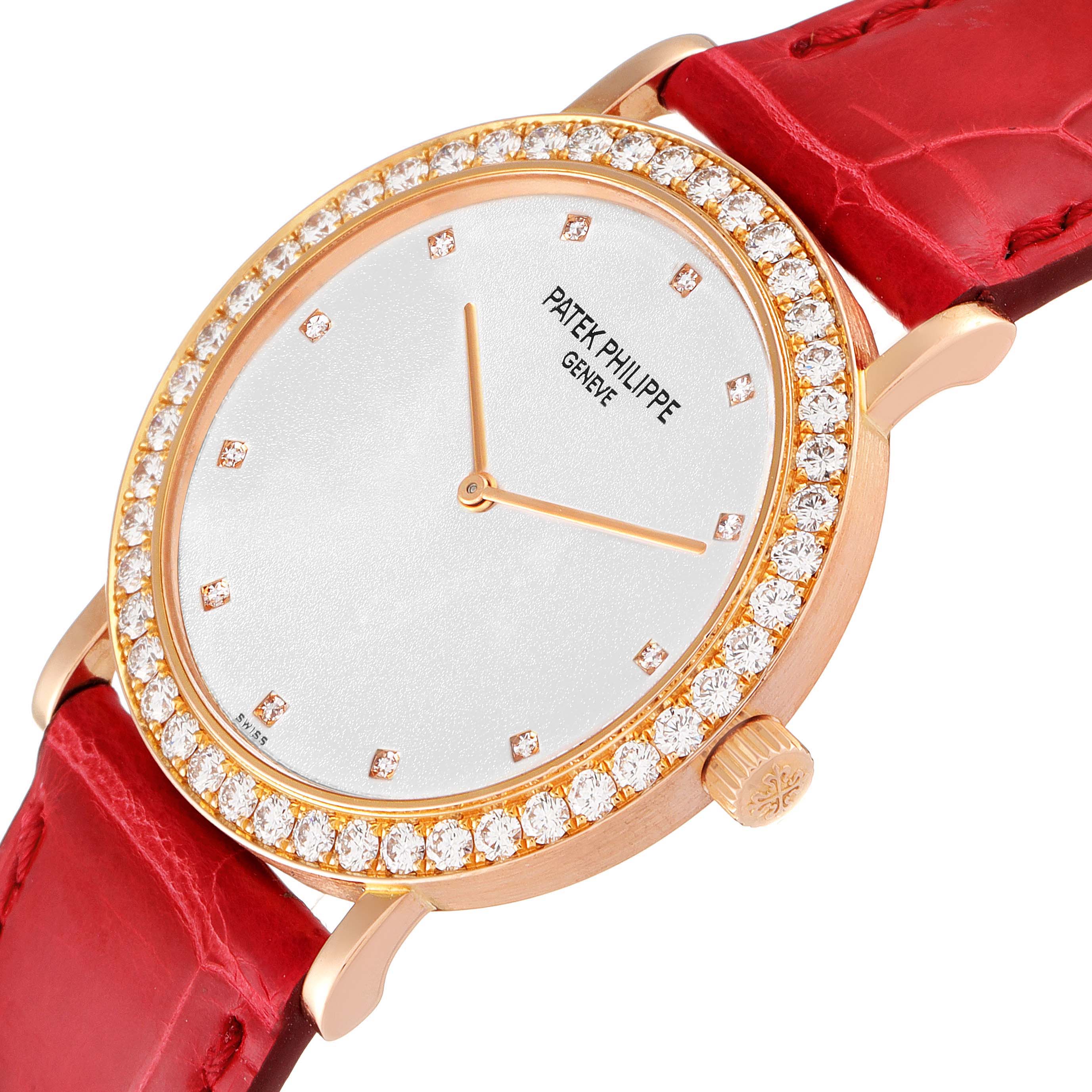 The Patek Philippe Calatrava 5006R Men's Rose Gold Silver Dial 5006R Men's Rose Gold Silver Dial model watch is shown at an angle highlighting its diamond-studded bezel and red leather strap.