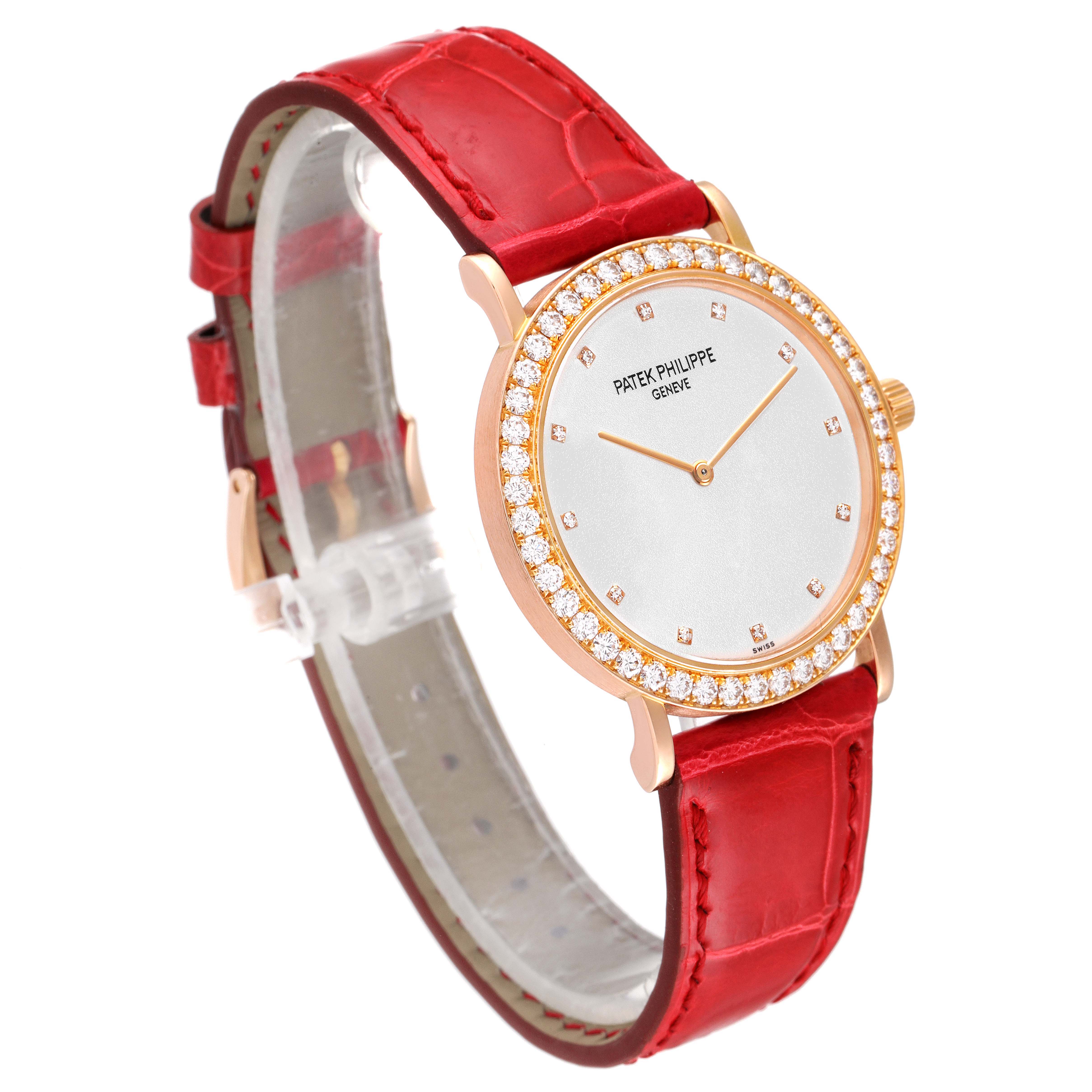 The image shows a Patek Philippe Calatrava 5006R Men's Rose Gold Silver Dial 5006R Men's Rose Gold Silver Dial watch at an angle, highlighting its red strap, diamond-encrusted bezel, and elegant face.