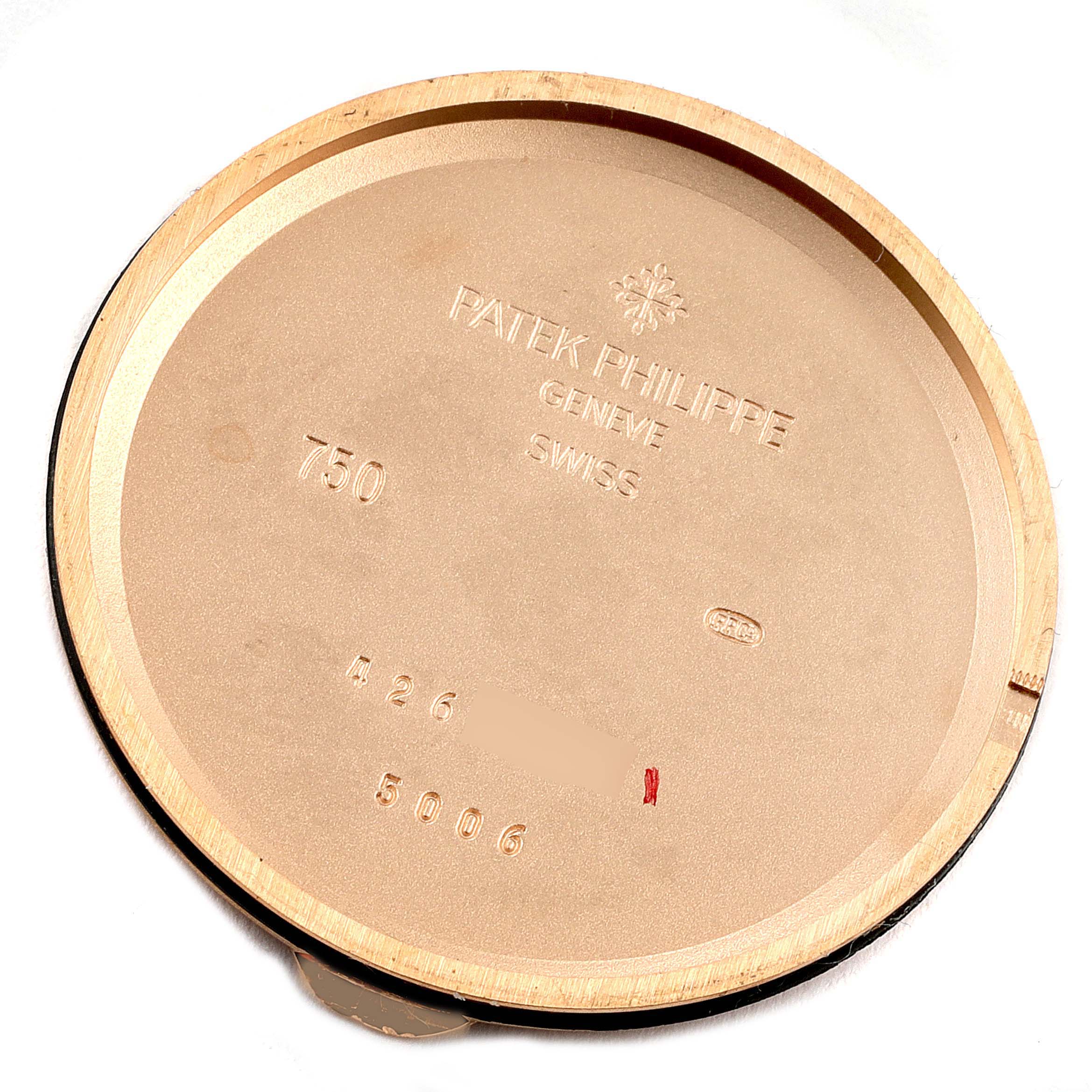 The image shows the backplate of a Patek Philippe Calatrava 5006R Men's Rose Gold Silver Dial 5006R Men's Rose Gold Silver Dial watch, featuring engraved text and markings.