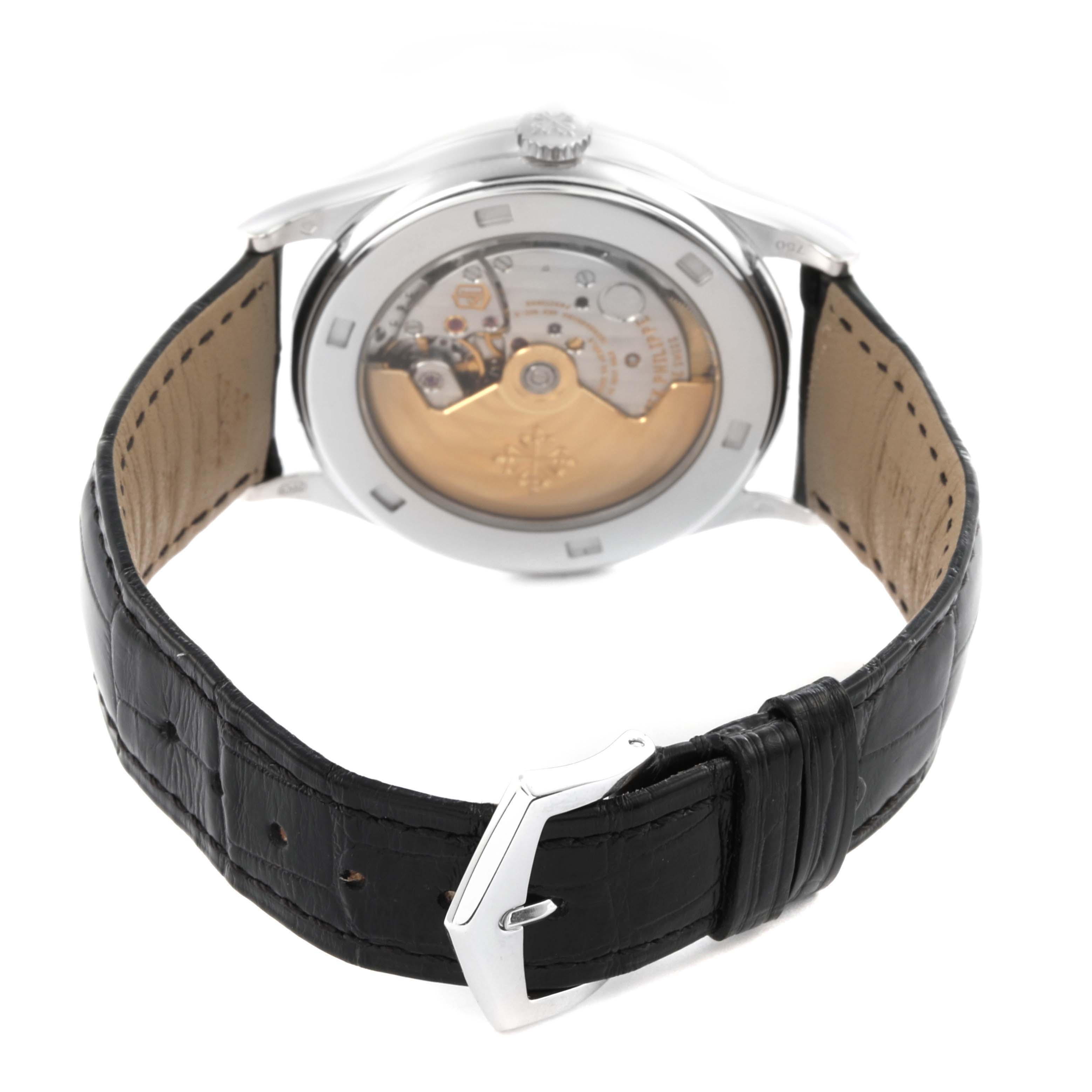 The image shows the back of a Patek Philippe Calatrava 5296G-010 Men
s White Gold Silver Dial 5296G-010 Men
s White Gold Silver Dial watch, highlighting its transparent case back and movement details.