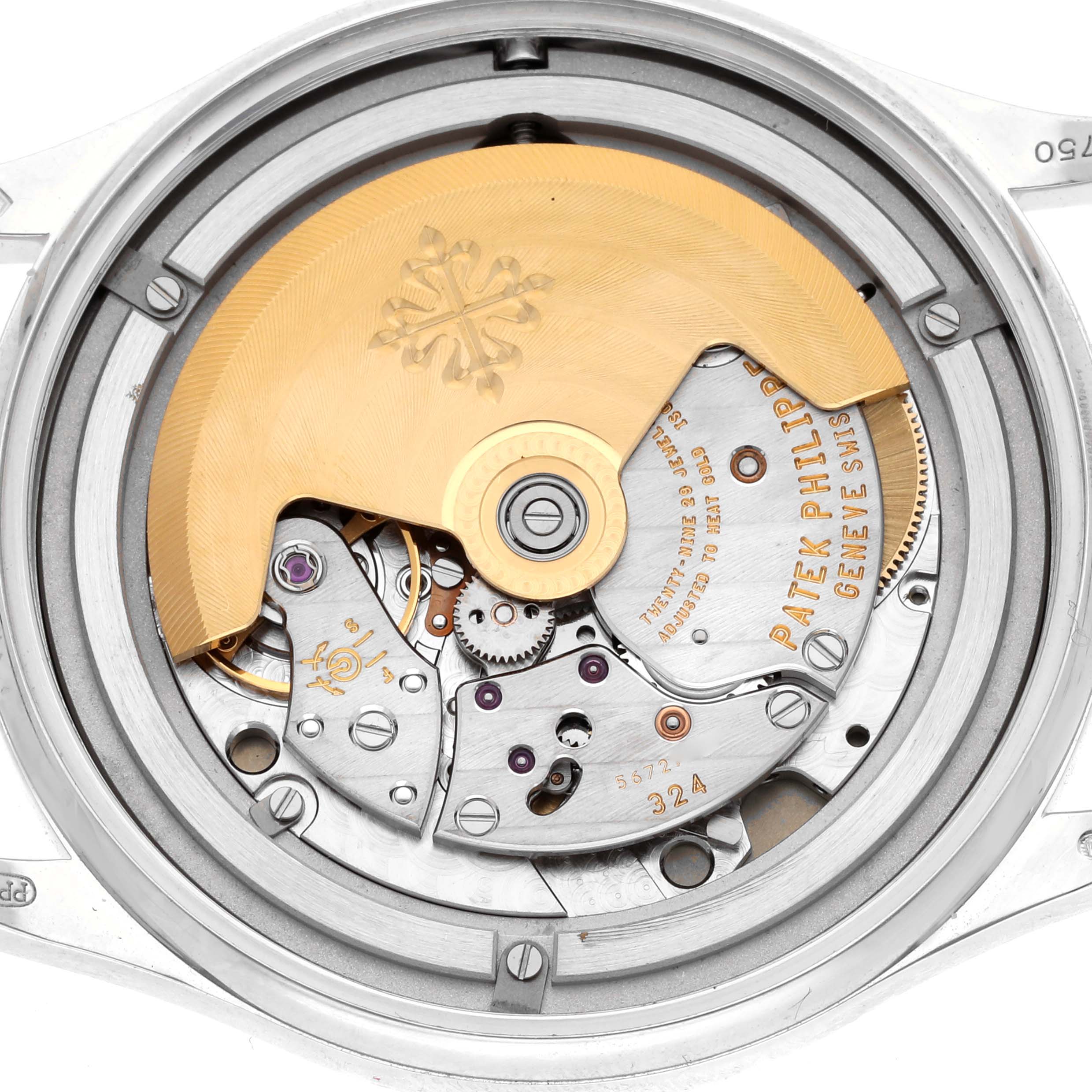 The image shows the movement of a Patek Philippe Calatrava 5296G-010 Men
s White Gold Silver Dial 5296G-010 Men
s White Gold Silver Dial watch, highlighting the automatic rotor and internal mechanisms.