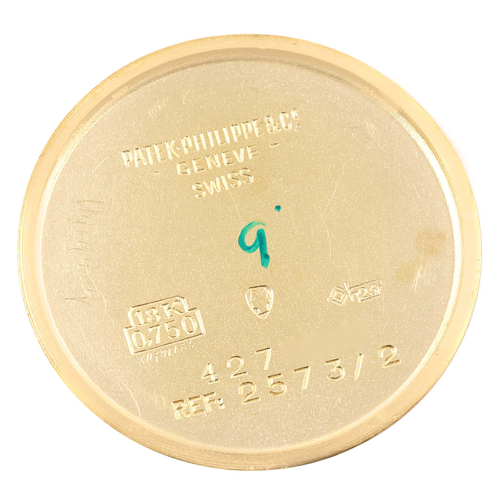 The image shows the case back of a vintage Patek Philippe watch, model reference number 2573/2, from an overhead angle.