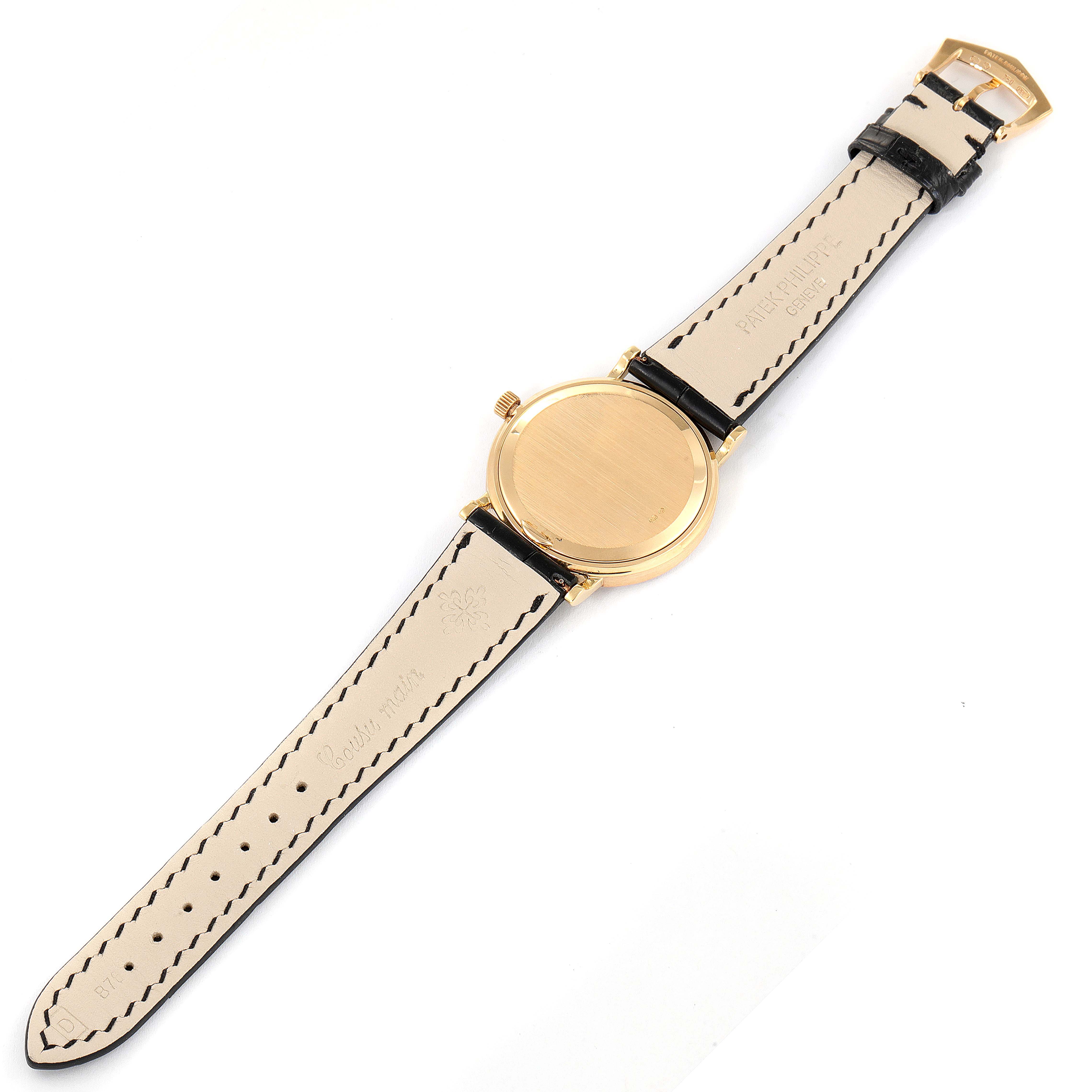 This image shows the back view of a Patek Philippe Calatrava 5006J Men's Yellow Gold White Dial 5006J Men's Yellow Gold White Dial watch, highlighting the strap, buckle, and case back.