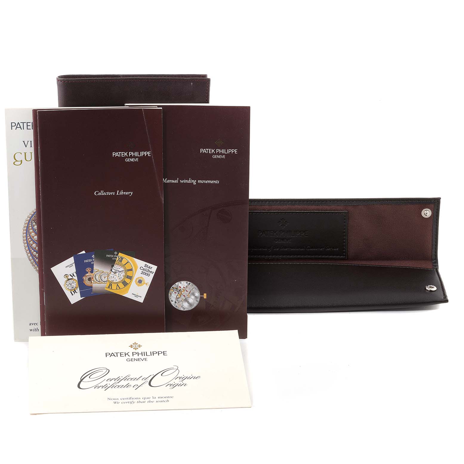 The image shows the box and papers set, including a wallet and manuals, for the Patek Philippe Calatrava 5006J Men's Yellow Gold White Dial 5006J Men's Yellow Gold White Dial watch.