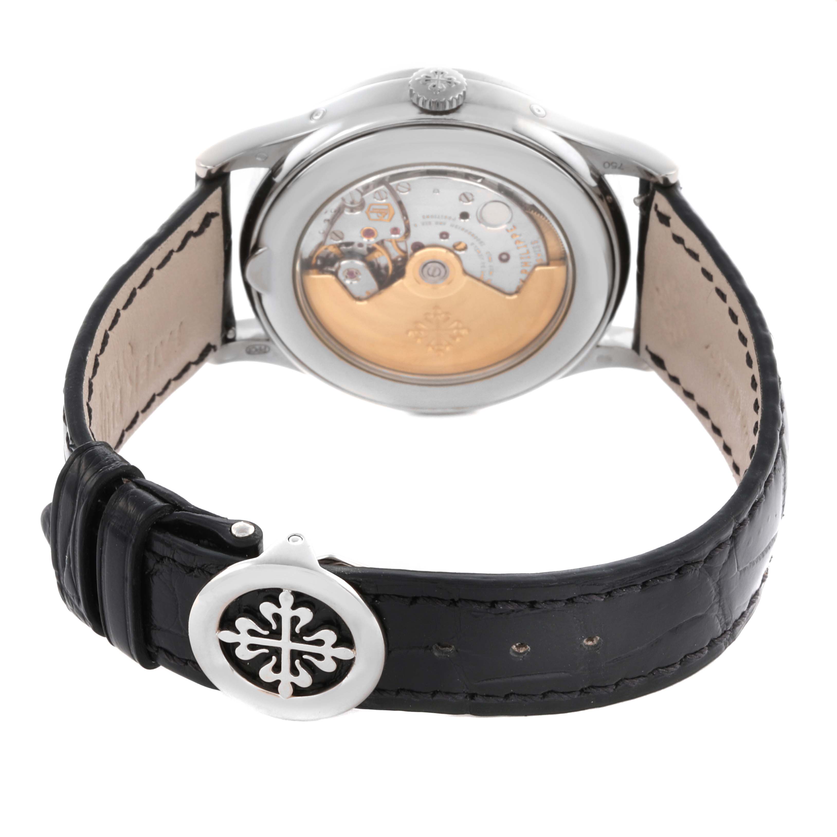 The Patek Philippe Complications 5396G-011 Men
s White Gold Silver Dial 5396G-011 Men
s White Gold Silver Dial watch is shown from the back, revealing its movement and featuring a black leather strap.