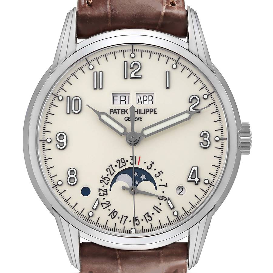 The Patek Philippe Complications watch is shown from the front, displaying the dial with day, date, and moon phase features.