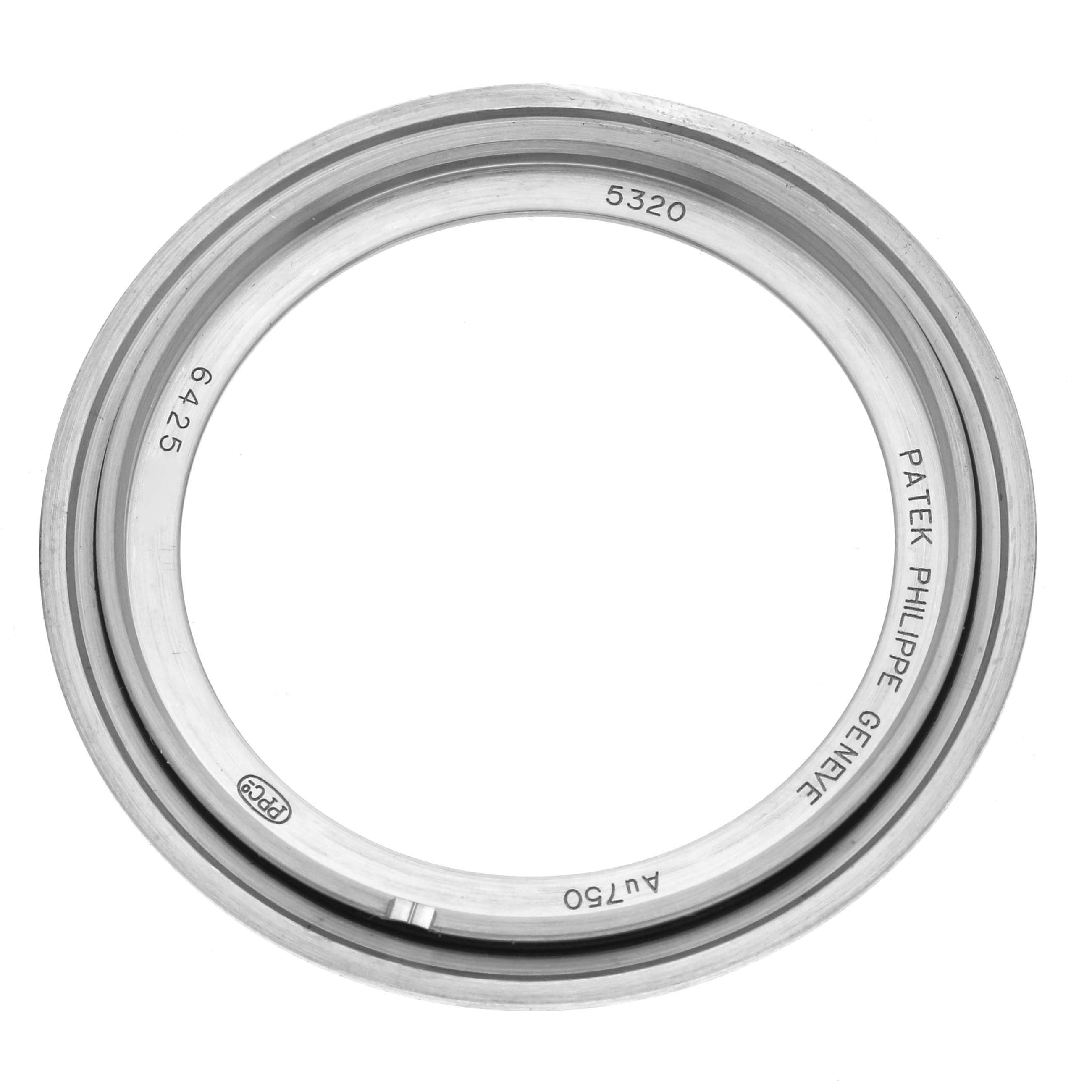 The image shows a circular metal ring, likely a watch case or bezel, for the Patek Philippe Complications 5320G-001 Men's White Gold White Dial 5320G-001 Men's White Gold White Dial model, viewed from above.