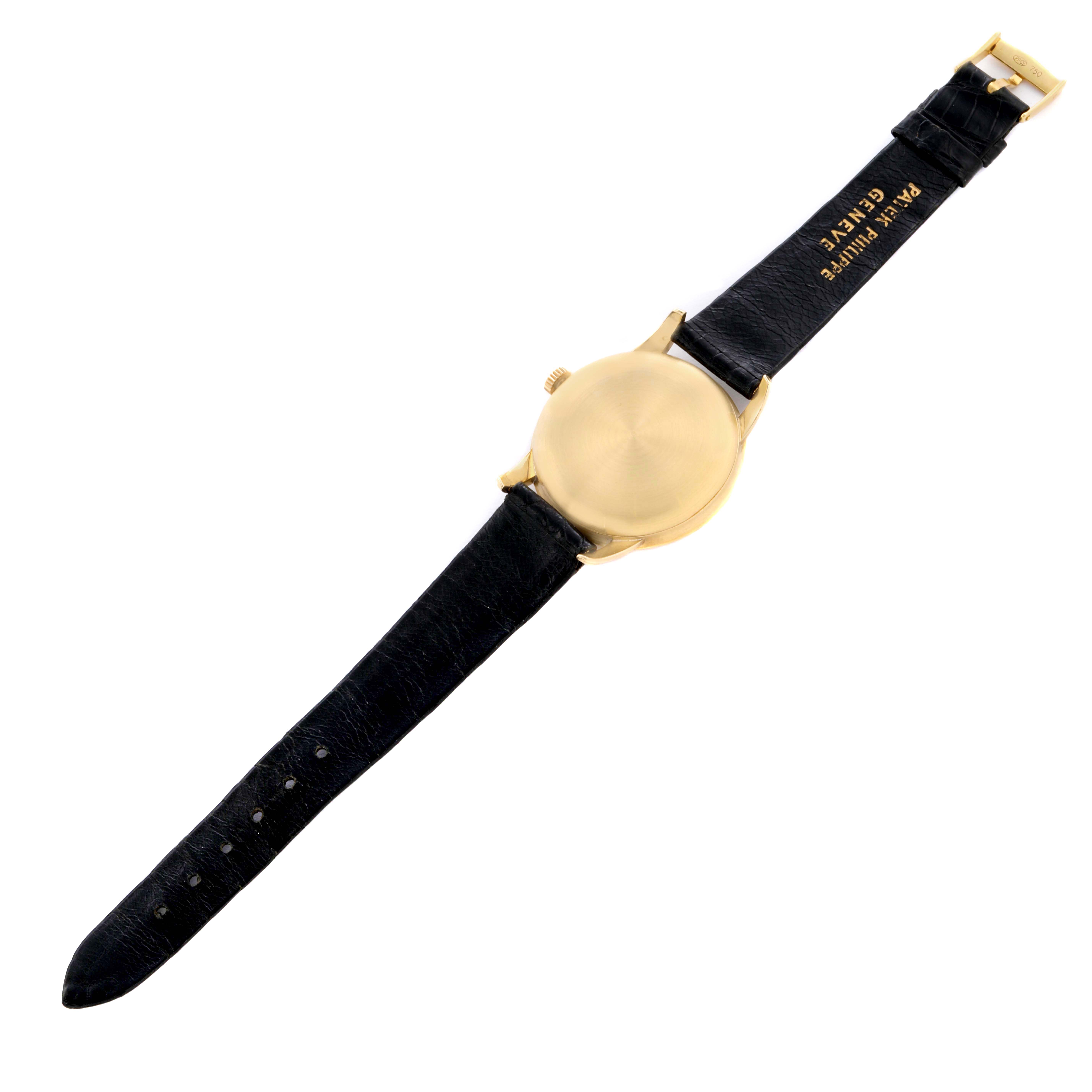 The image shows the back and strap of a Patek Philippe Calatrava 2481 Men's Yellow Gold Silver Dial watch, displaying the gold case and black leather band.