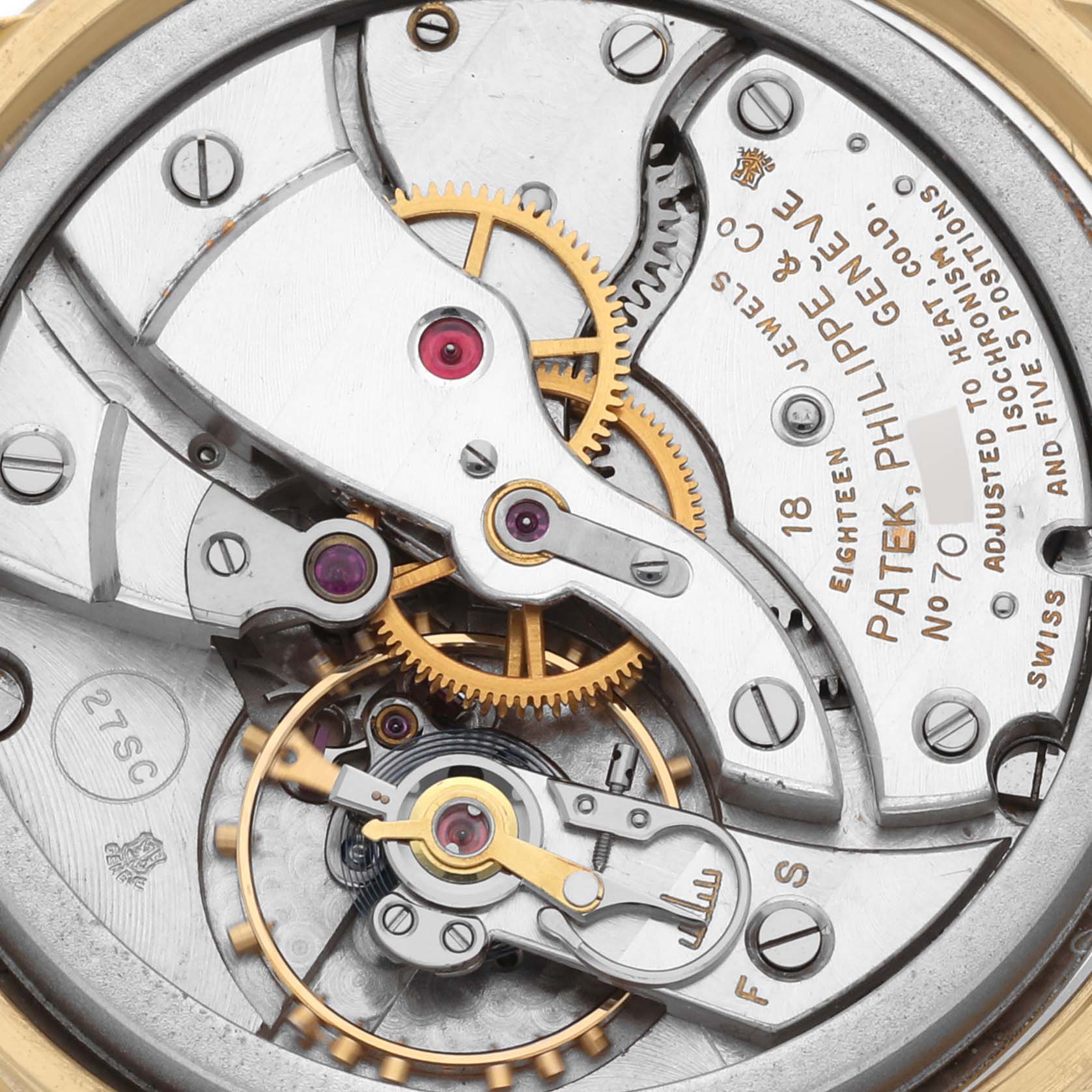 The image shows an up-close view of the movement of a Patek Philippe Calatrava 2481 Men's Yellow Gold Silver Dial 2481 Men's Yellow Gold Silver Dial watch, highlighting its gears and intricate mechanics.
