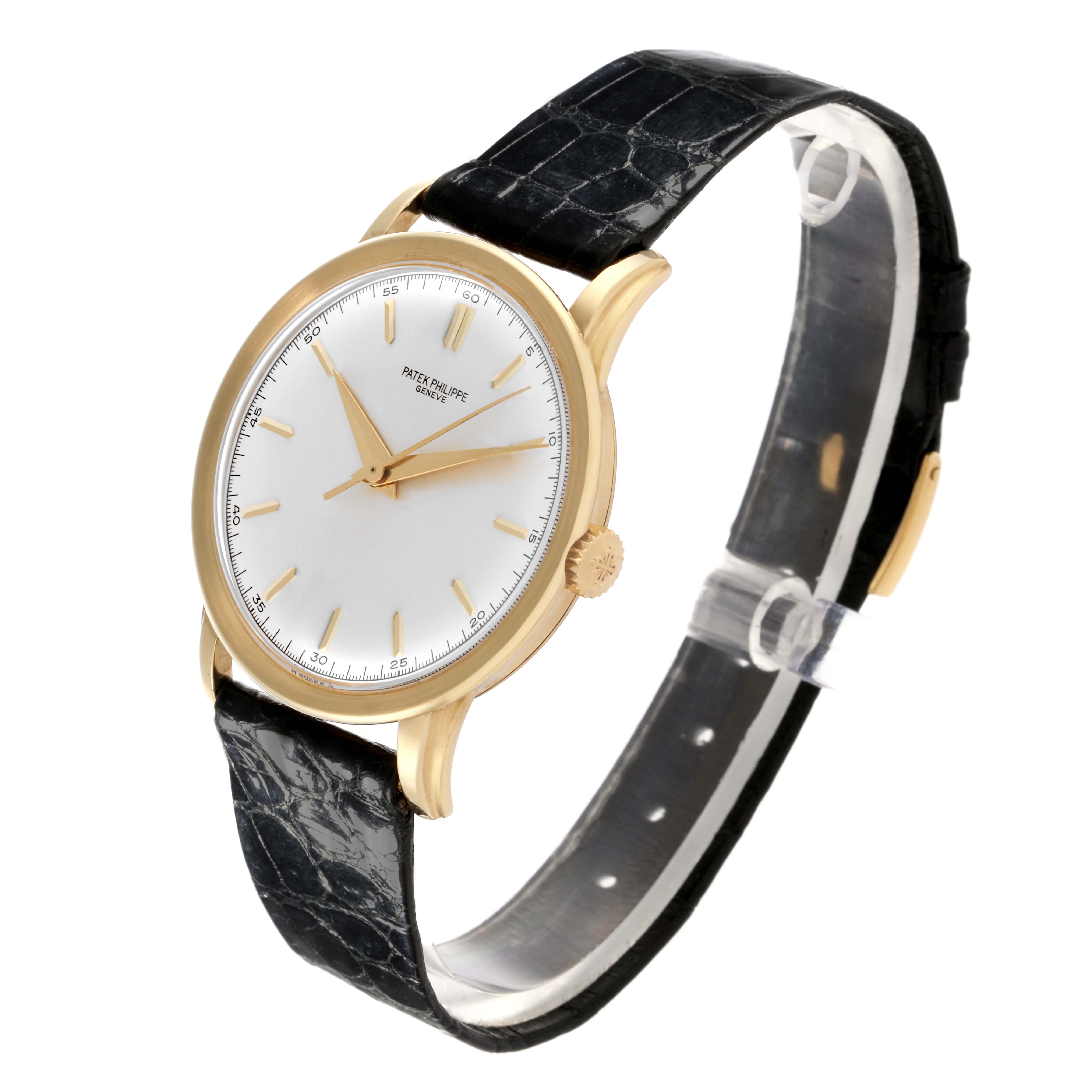 The image shows a side angle of the Patek Philippe Calatrava 2481 Men's Yellow Gold Silver Dial 2481 Men's Yellow Gold Silver Dial watch, highlighting the face, gold case, and black leather strap.