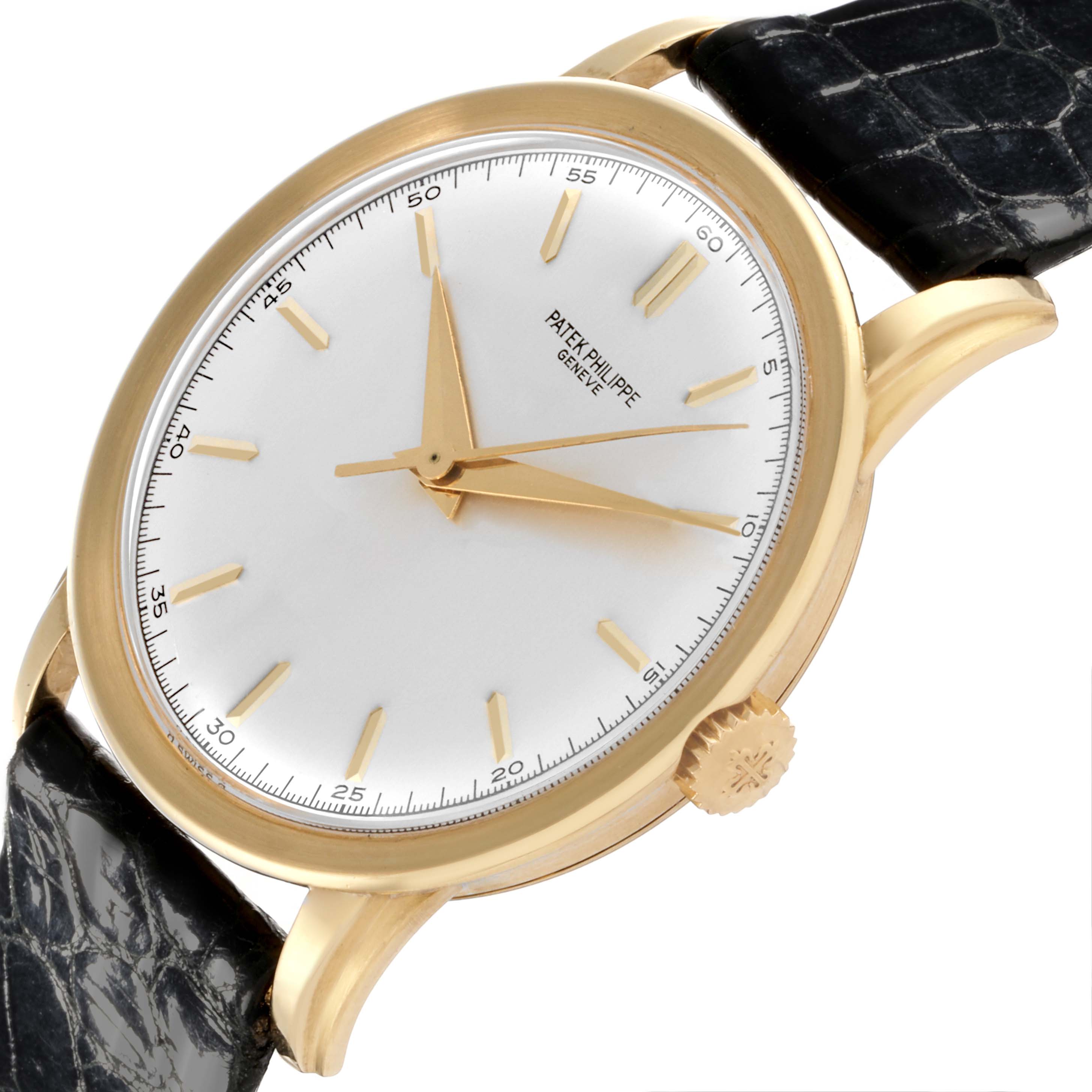 The image shows a side angle of the Patek Philippe Calatrava 2481 Men's Yellow Gold Silver Dial 2481 Men's Yellow Gold Silver Dial, highlighting the white dial, gold hands, and black strap.