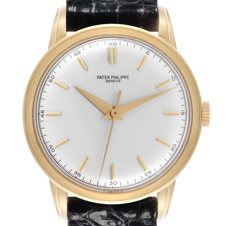 The Calatrava model by Patek Philippe is shown from the front, displaying the dial, hands, hour markers, and leather strap.