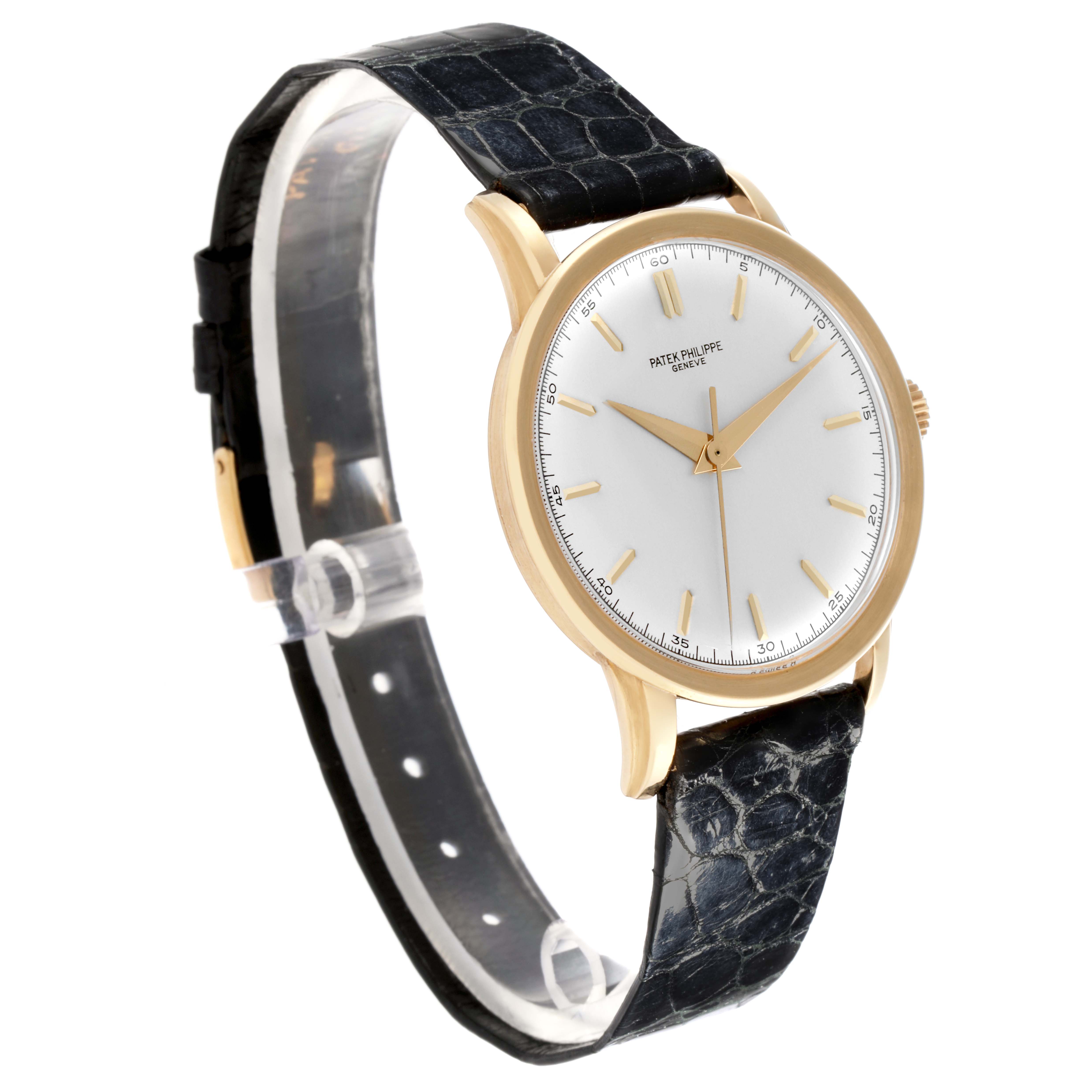 The Patek Philippe Calatrava 2481 Men's Yellow Gold Silver Dial 2481 Men's Yellow Gold Silver Dial watch is shown at a three-quarter angle, highlighting the dial, case, and leather strap.