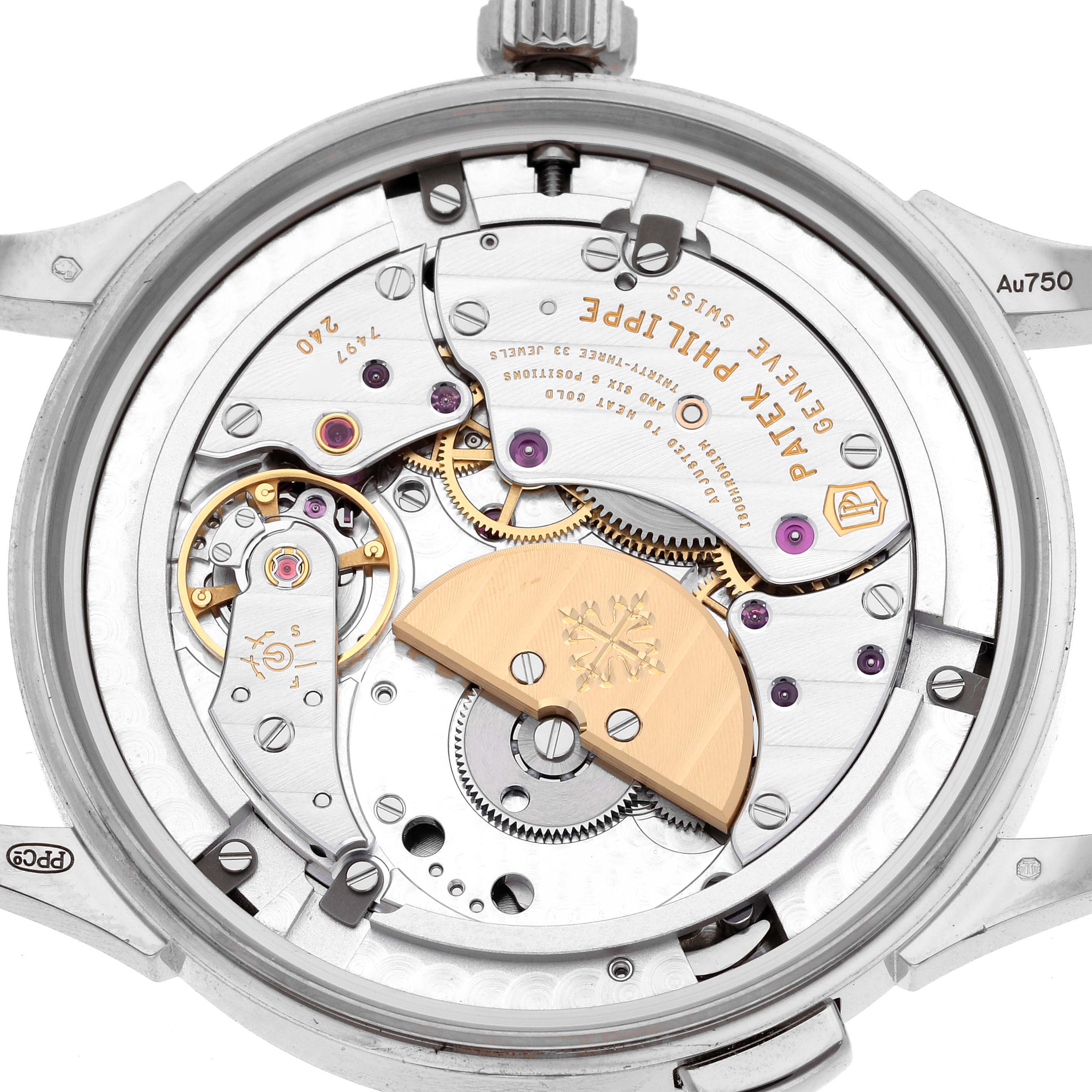 The image shows a close-up, rear view of the Patek Philippe Complications 5231G-001 Men's White Gold Silver Dial watch, highlighting its intricate movement and rotor.