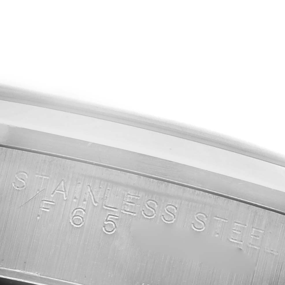 The image shows a close-up of the stainless steel case back of the Rolex Air-King 14000M Men's Stainless Steel Pink Dial 14000M Men's Stainless Steel Pink Dial watch, focusing on engraved details.