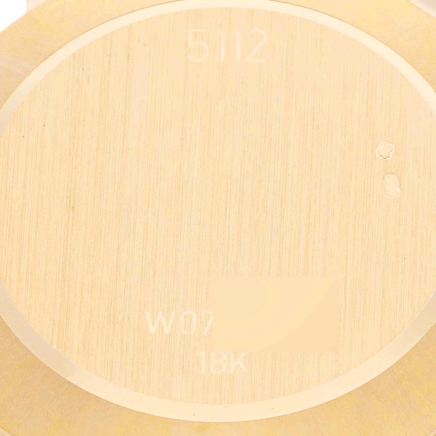 The image shows the back of a Rolex Cellini 5112/8 Men
s Yellow Gold Champagne Dial 5112/8 Men
s Yellow Gold Champagne Dial model watch, highlighting the engraving and gold finish.