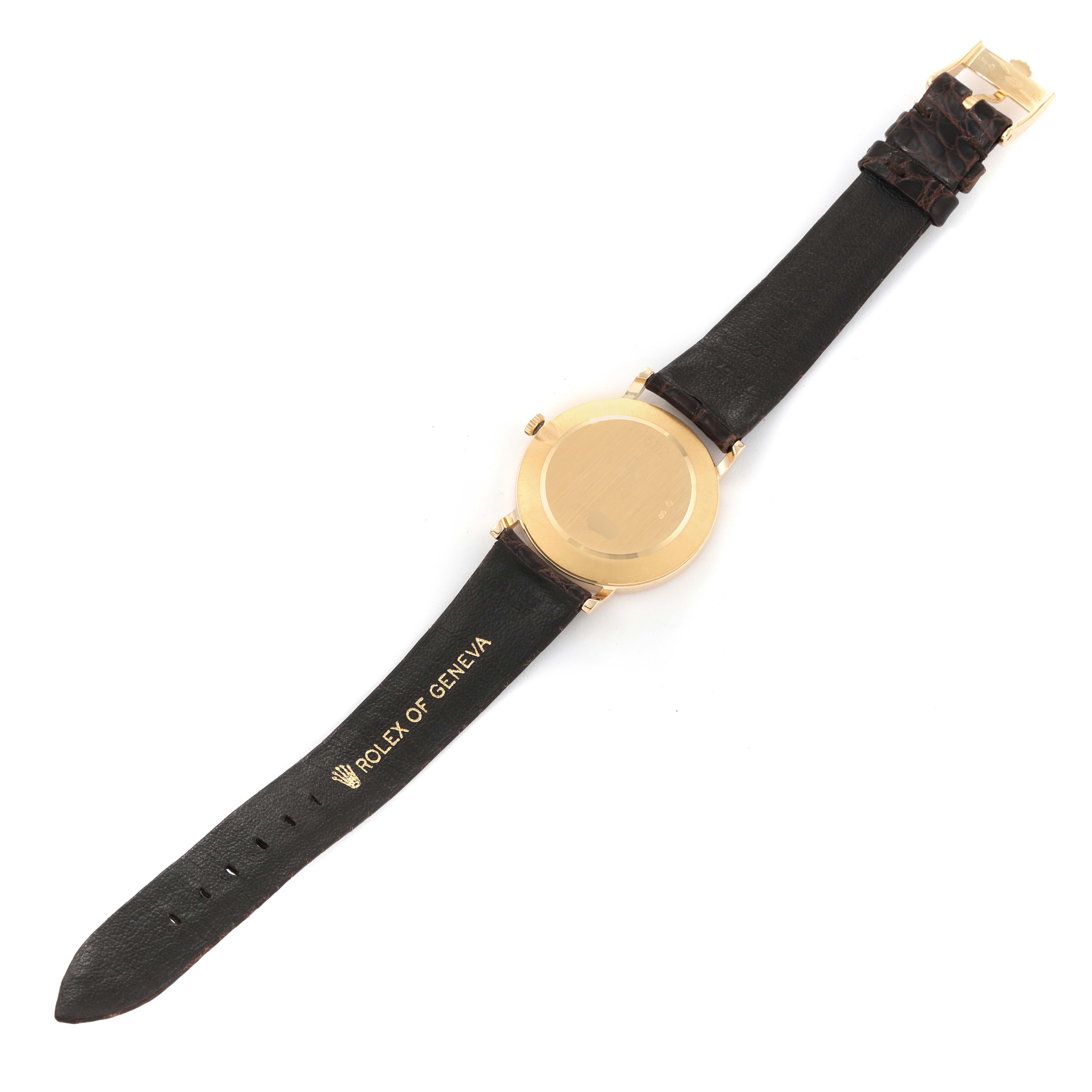 The image shows the back of the Rolex Cellini 5112/8 Men
s Yellow Gold Champagne Dial 5112/8 Men
s Yellow Gold Champagne Dial watch with its strap fully extended, displaying the branding "Rolex of Geneva" on the leather strap.