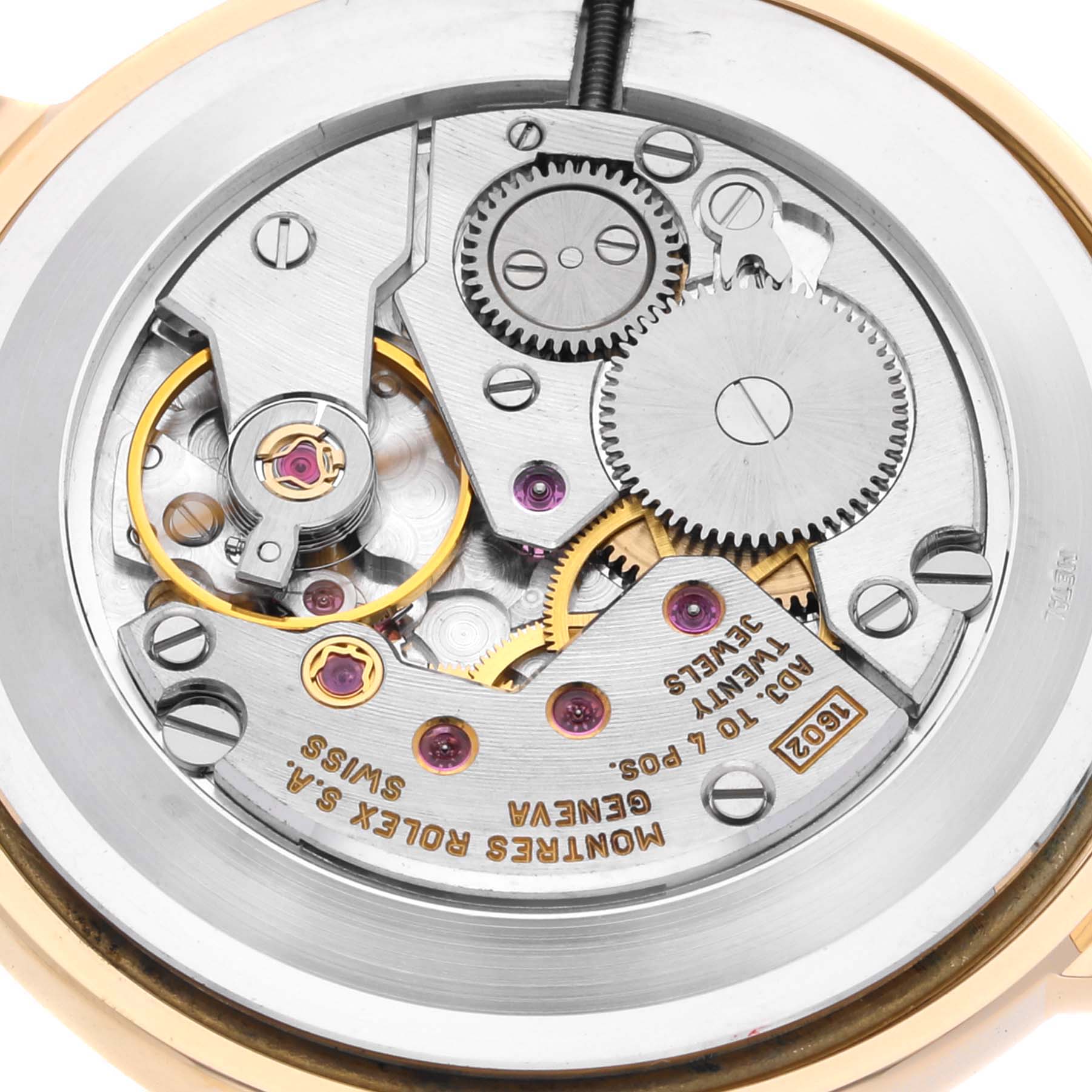 The image shows the movement mechanism of a Rolex Cellini 5112/8 Men
s Yellow Gold Champagne Dial 5112/8 Men
s Yellow Gold Champagne Dial watch, including gears, jewels, and inscriptions.