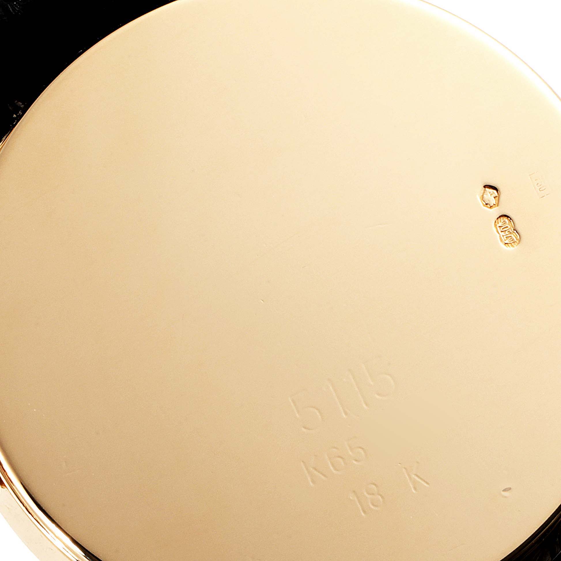 The image shows the back case of a Rolex Cellini 5115 Men's Yellow Gold Mother of Pearl Dial 5115 Men's Yellow Gold Mother of Pearl Dial watch, focusing on its engravings and hallmarks.