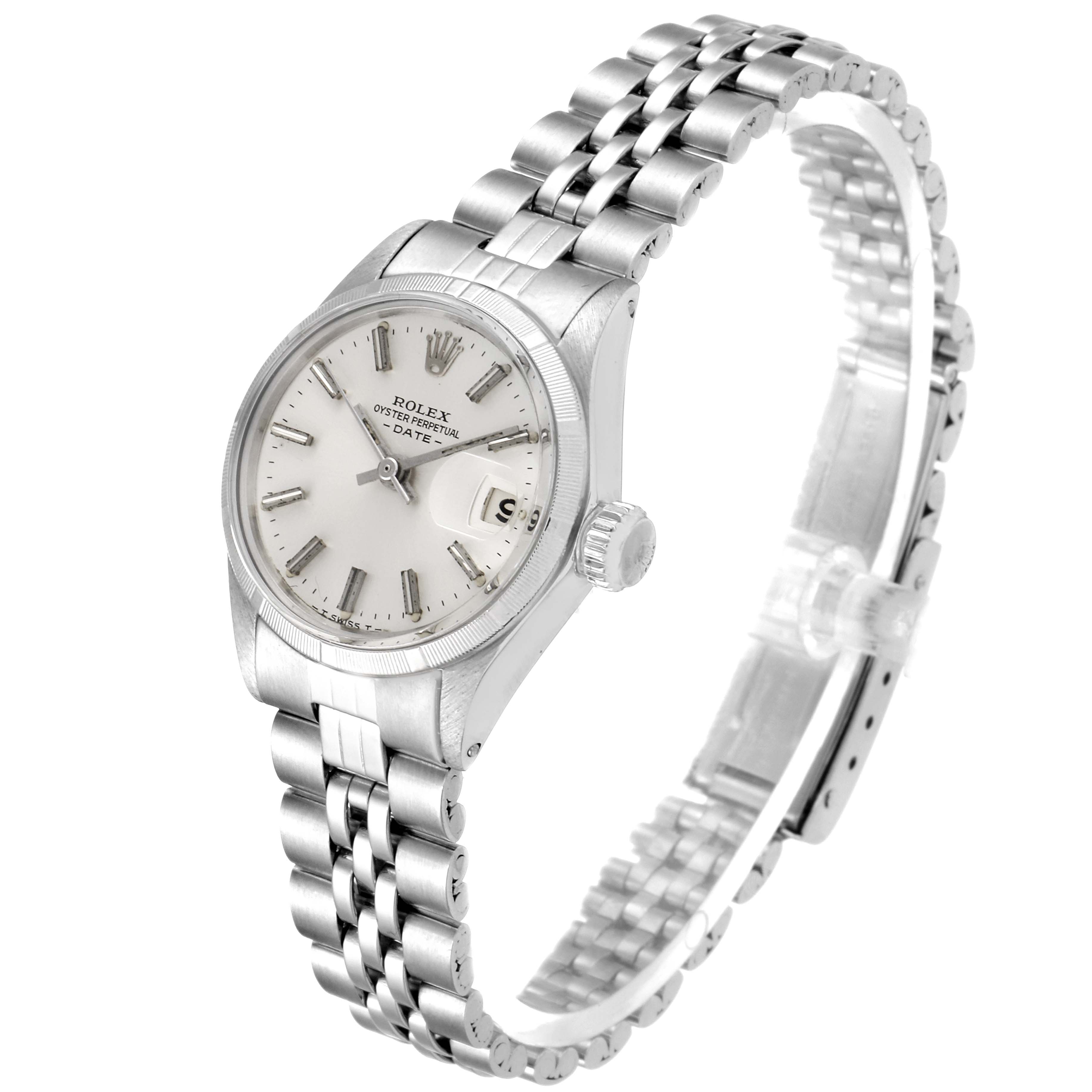 The image shows a Rolex Date 6519 Women
s Stainless Steel Silver Dial 6519 Women
s Stainless Steel Silver Dial model watch from a slight angle, highlighting its face, bezel, crown, and part of the bracelet.