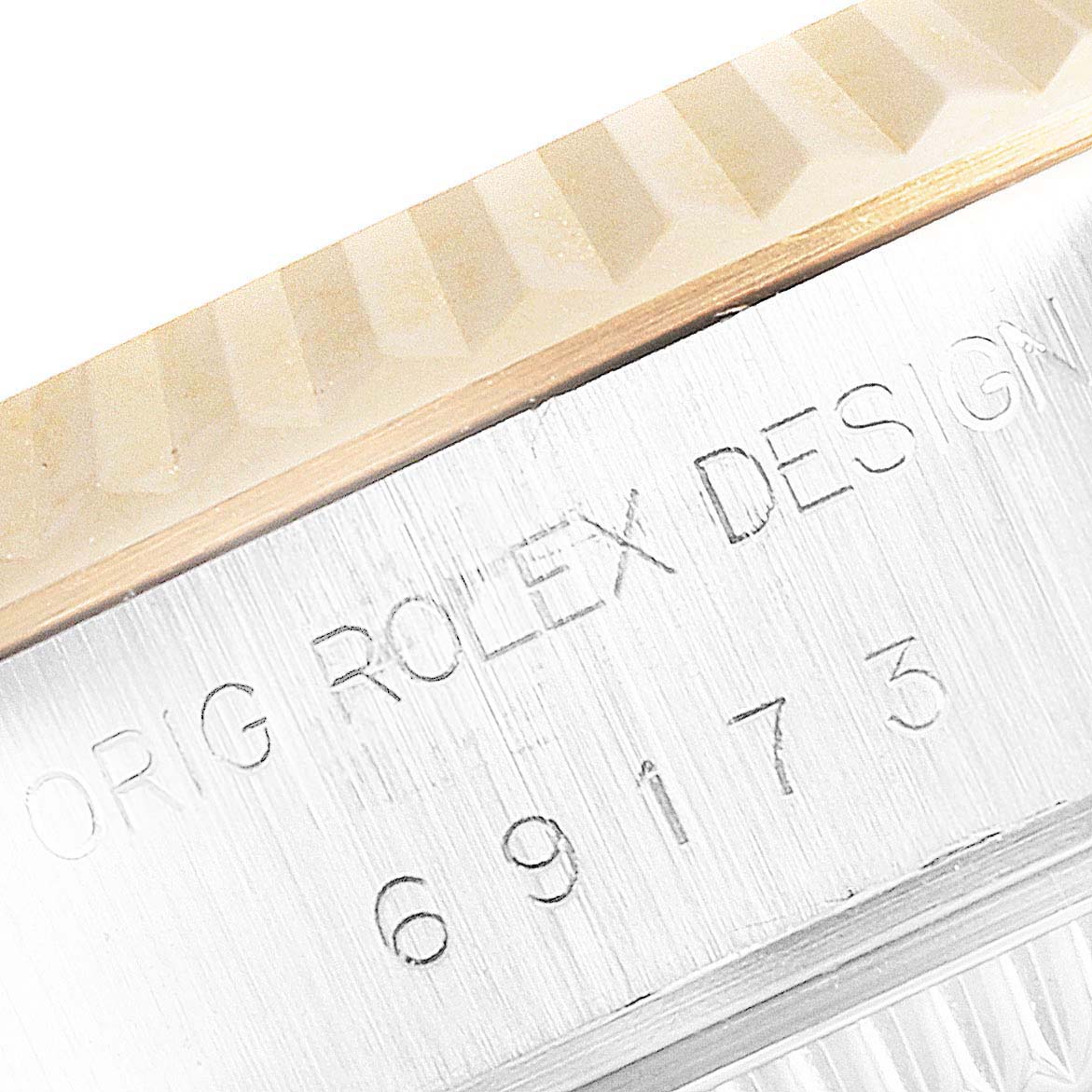 This image shows a close-up of the bezel and engraved side of a Rolex Datejust 69173 Women's Steel and Gold (two tone) Blue Dial 69173 Women's Steel and Gold (two tone) Blue Dial watch.