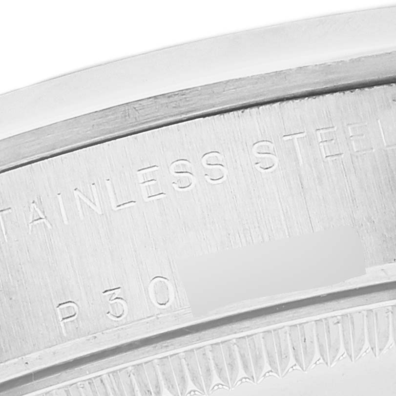 This image shows a close-up of the stainless steel back case of a Mid-Size Rolex watch, highlighting the engraved text.