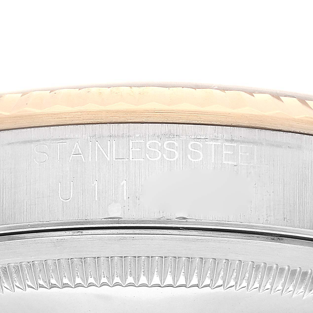 This image shows a close-up of the stainless steel part and fluted bezel of a Rolex Datejust 16233 Men's Steel and Gold (two tone) Blue Dial 16233 Men's Steel and Gold (two tone) Blue Dial watch.