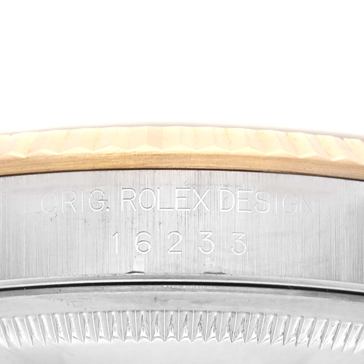 This image shows the engraved model number "16233" and "ORIG. ROLEX DESIGN" on the side of a Rolex Datejust 16233 Men's Steel and Gold (two tone) Blue Dial 16233 Men's Steel and Gold (two tone) Blue Dial watch.