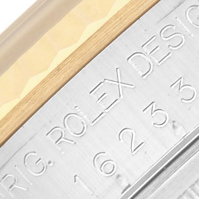 The image shows a close-up of the engraved side of a Rolex Datejust 16233 Men's Steel and Gold (two tone) Mother of Pearl Dial 16233 Men's Steel and Gold (two tone) Mother of Pearl Dial, highlighting the model number and brand name.