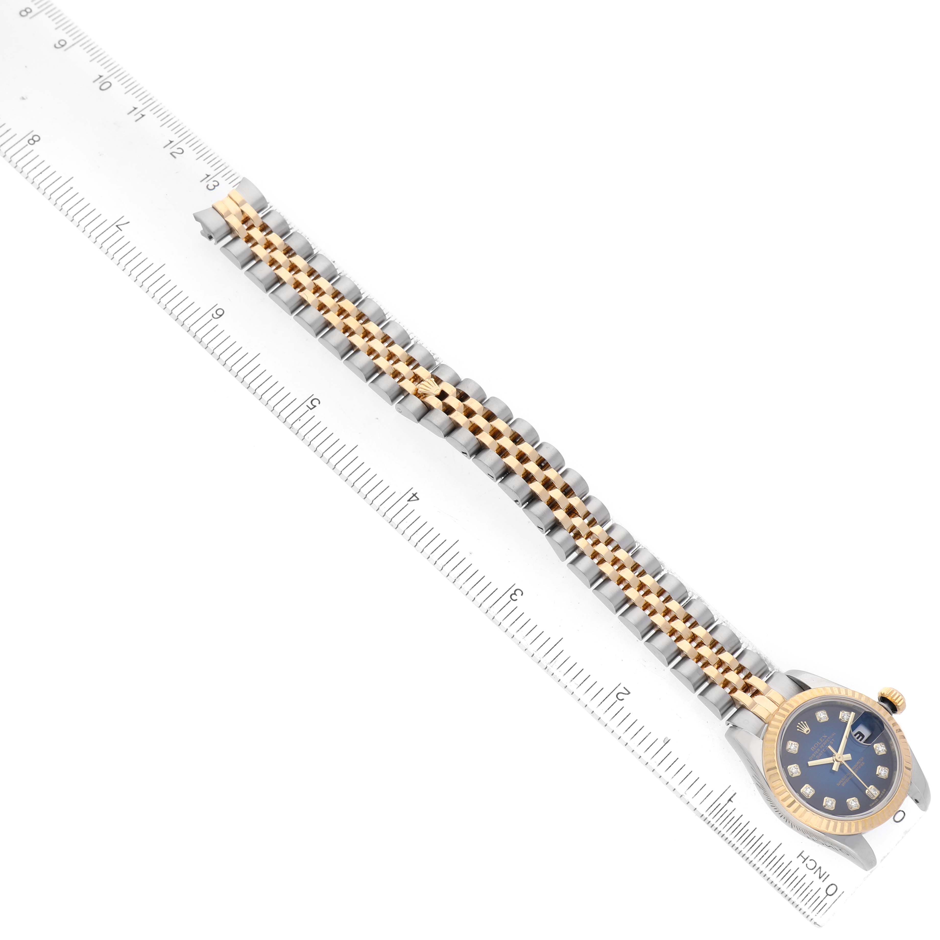The Rolex Datejust 179173 Women's Steel and Gold (two tone) Blue Dial watch is displayed horizontally, showing the full bracelet, case, and part of the face.