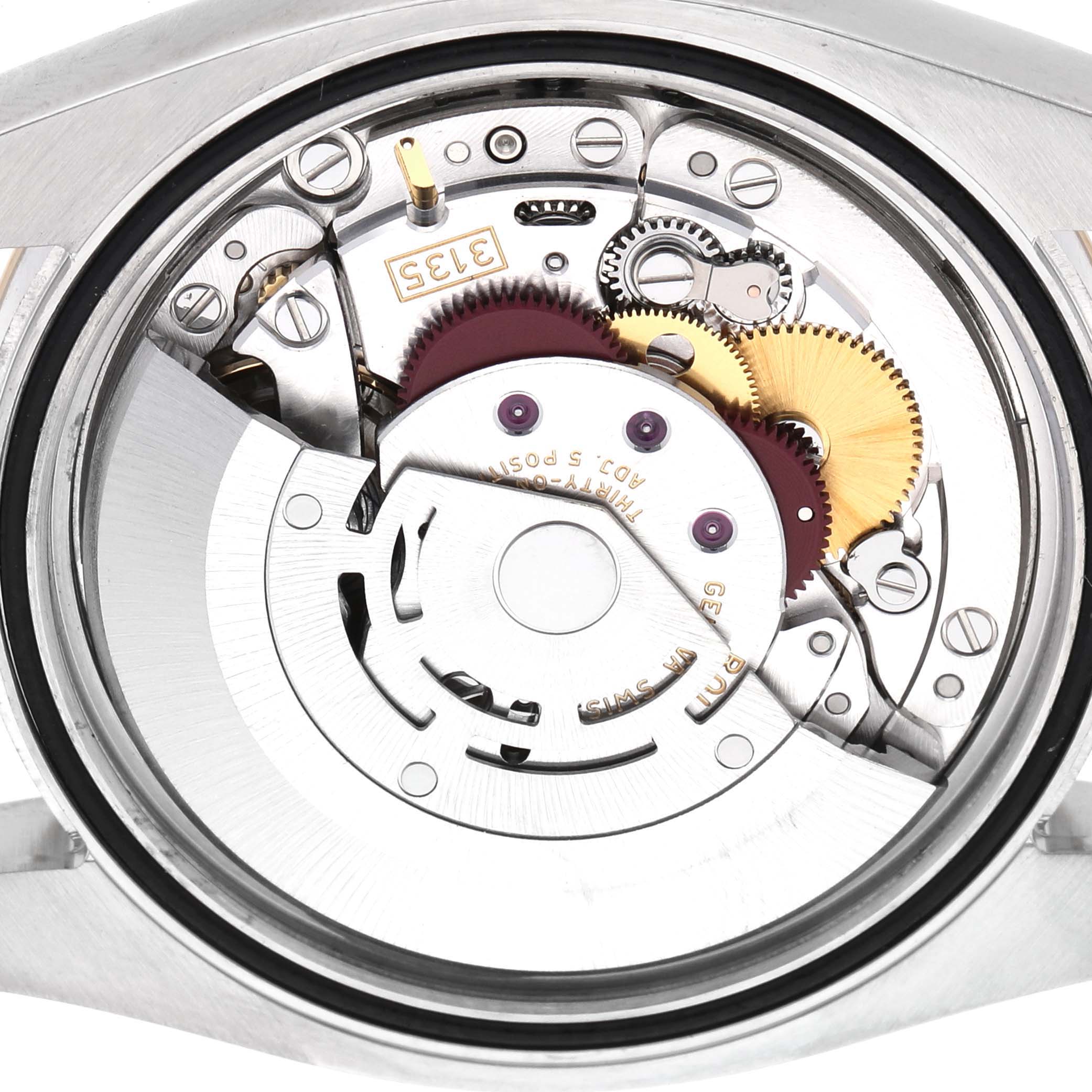 The image shows the movement of a Rolex Datejust 116203 Men's Steel and Gold (two tone) Champagne Dial watch, highlighting gears and internal components from the back.