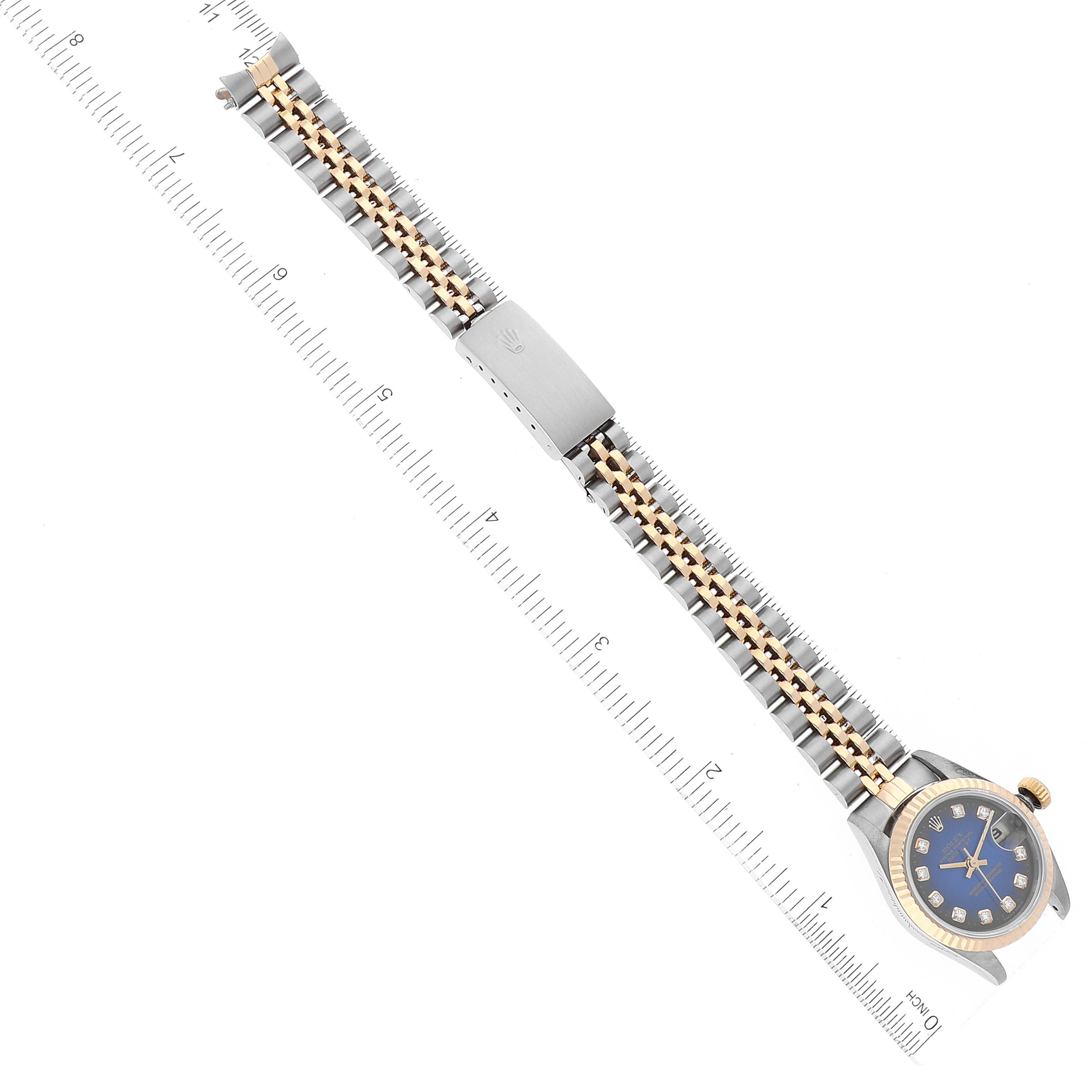 The image shows a top-down view of a Rolex Datejust 69173 Women's Steel and Gold (two tone) Blue Dial 69173 Women's Steel and Gold (two tone) Blue Dial watch, including the face, bezel, bracelet, and clasp, with a ruler for scale.