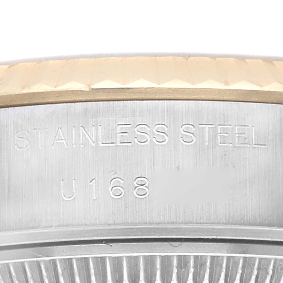 This is a close-up of the side engraving on a Rolex Datejust 69173 Women's Steel and Gold (two tone) Champagne Dial 69173 Women's Steel and Gold (two tone) Champagne Dial, showing "STAINLESS STEEL" and part of the serial number.