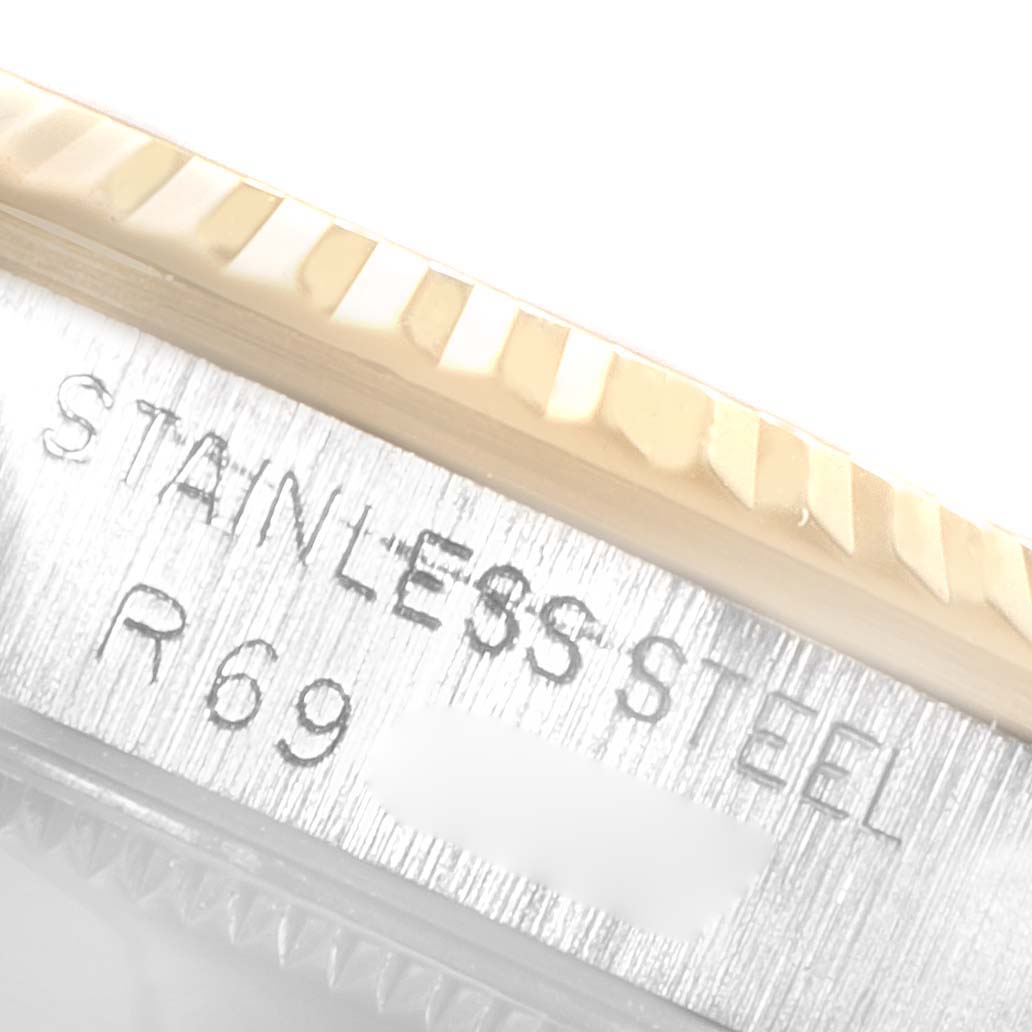 The image shows a close-up angle of the case edge and part of the fluted bezel on a Mid-Size Rolex watch.